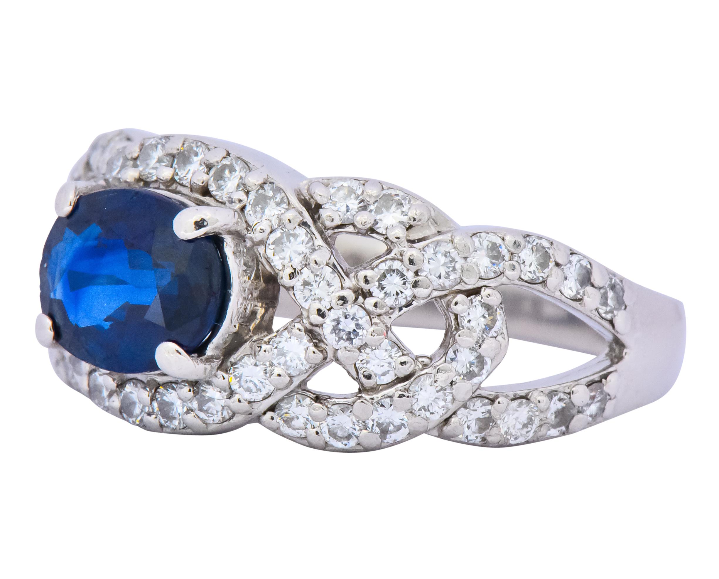 Centering an oval cut sapphire weighing approximately 1.30 carats, deep blue color

Accompanied by round brilliant cut diamond accents, weighing 0.77 carat total, GHI color and VS to SI clarity

Prong set sapphire with pierced woven lattice-style