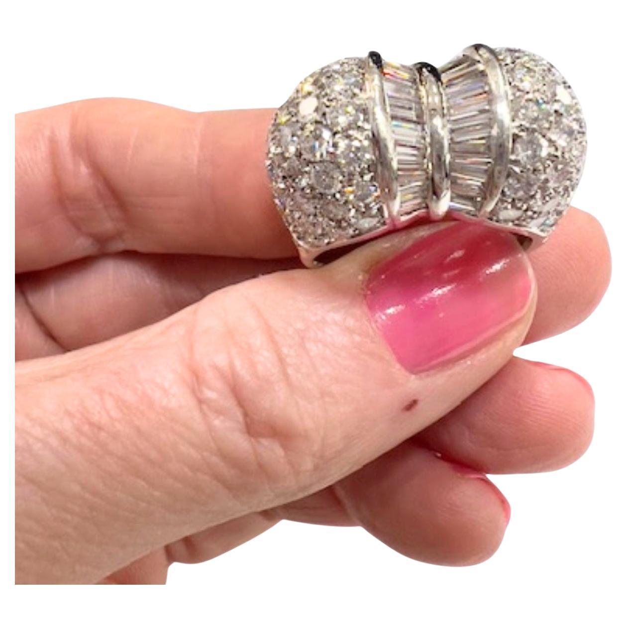 A stunning contemporary ring from the 20th century, crafted in 18k white gold and set with a mix of brilliant, trapezoid, and baguette diamonds, totaling 5.84 ct.

**IN STOCK**

Technical Specifications:

Metal: 18k White Gold
Weight: 15.04