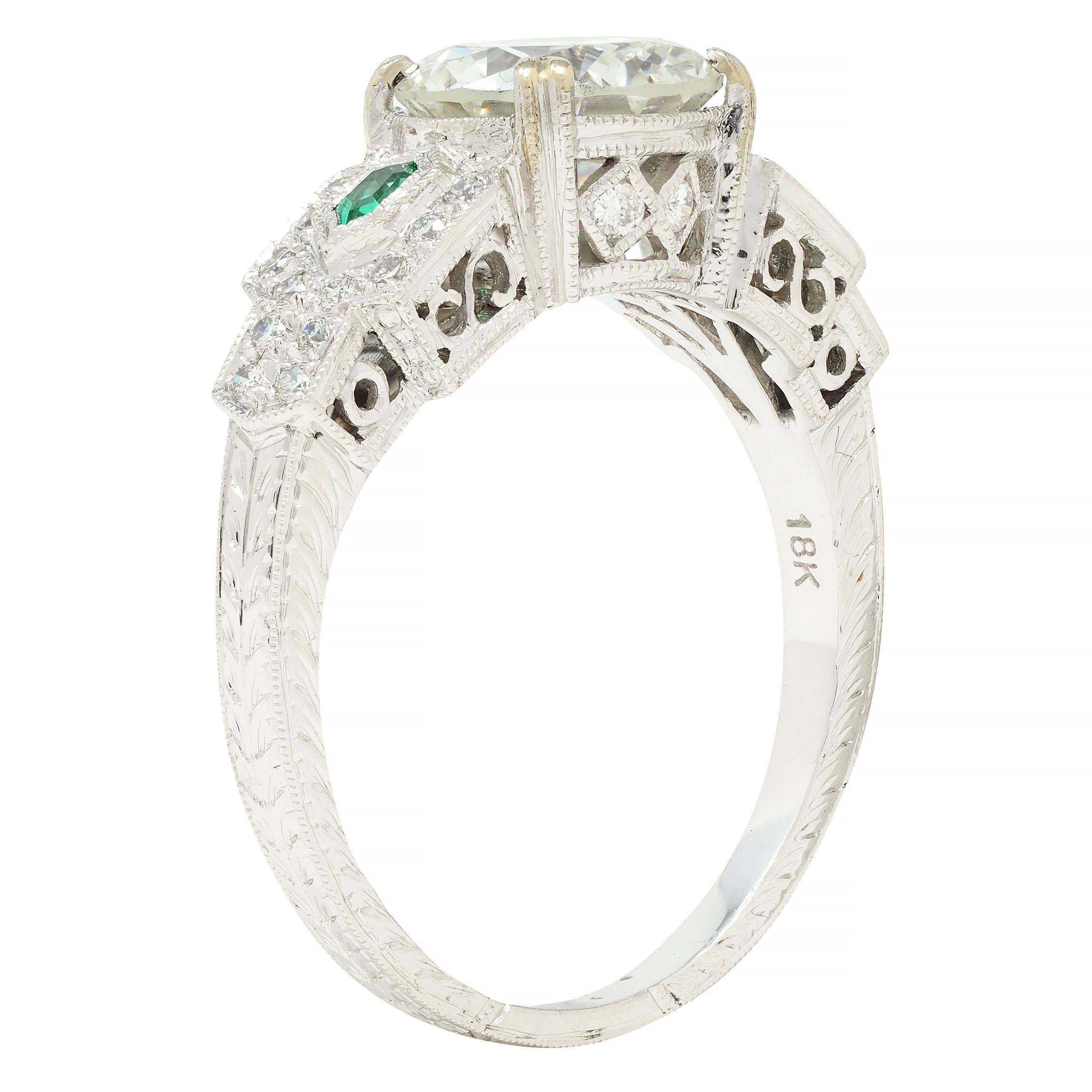 Centering an old European cut diamond weighing 1.83 carats - I color with SI1 clarity
Set with split prongs in stylized basket and flanked by hexagonal cut emeralds
Weighing approximately 0.06 carat total - bezel set in geometric form shoulders
With