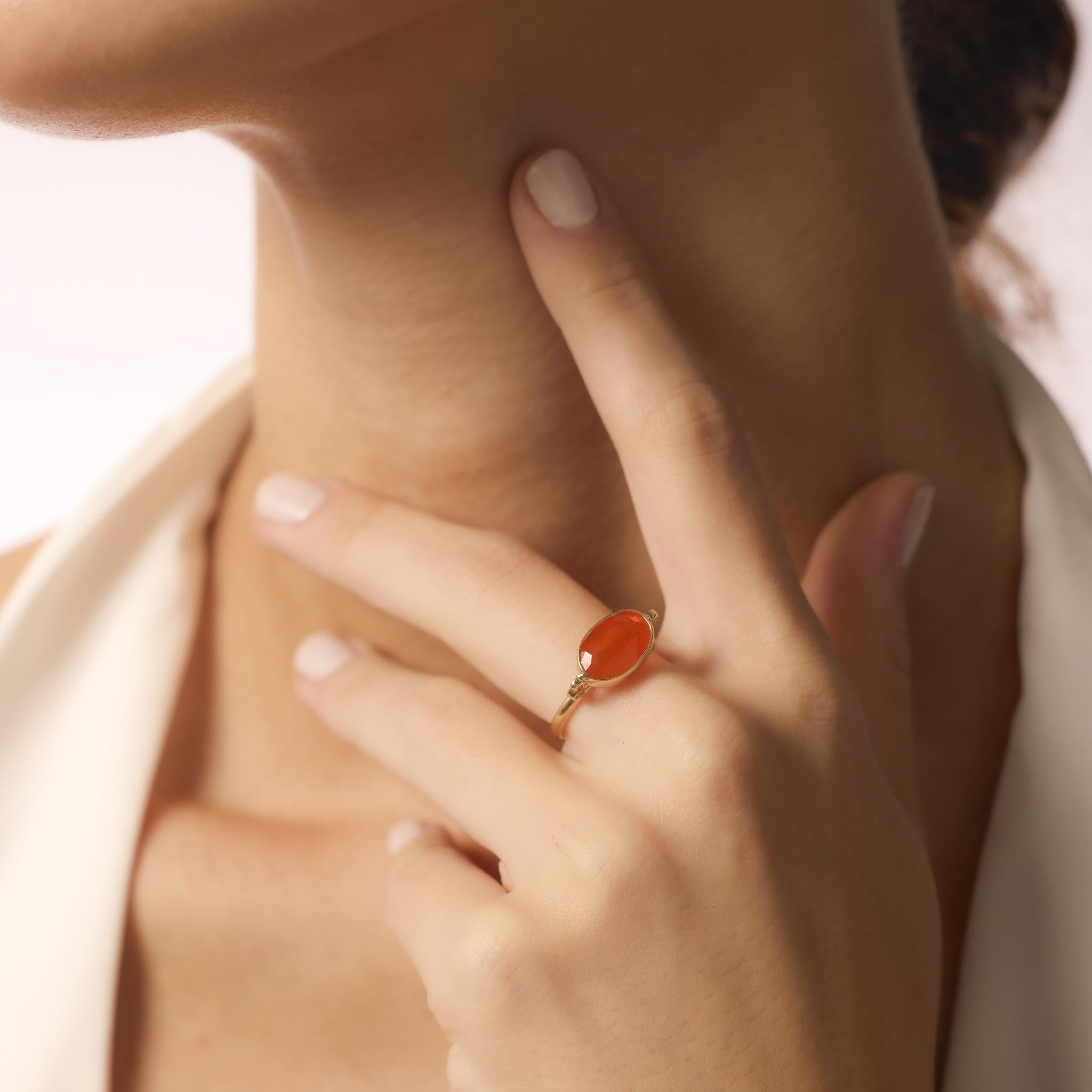 This contemporary ring features a 2.30ct oval fire opal set in sleek 14k yellow gold, highlighting the stone’s vibrant glow with a lightweight, elegant design.
