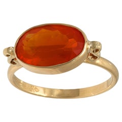 Contemporary 2.30 carat fire opal 14k yellow gold bezel ring