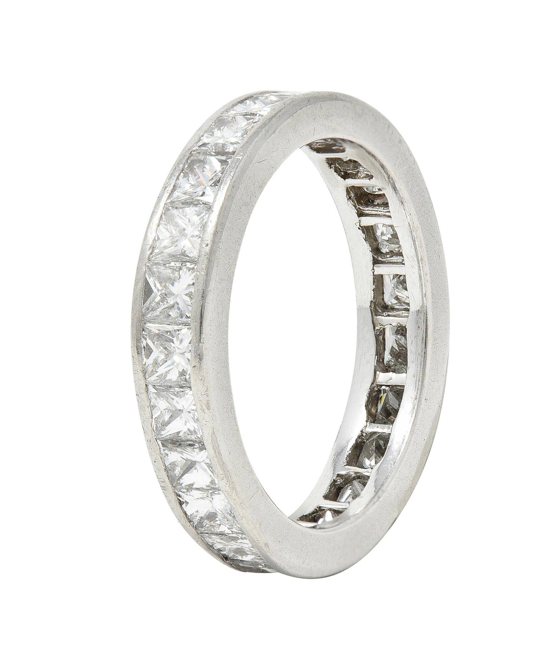 Band ring features princess cut diamonds channel set fully around
Weighing approximately 2.30 carat total - G/H in color with VS clarity
With high polished finish
Tested as platinum
Circa: 2000s
Ring size: 6 1/4 and not sizable
Measures north to