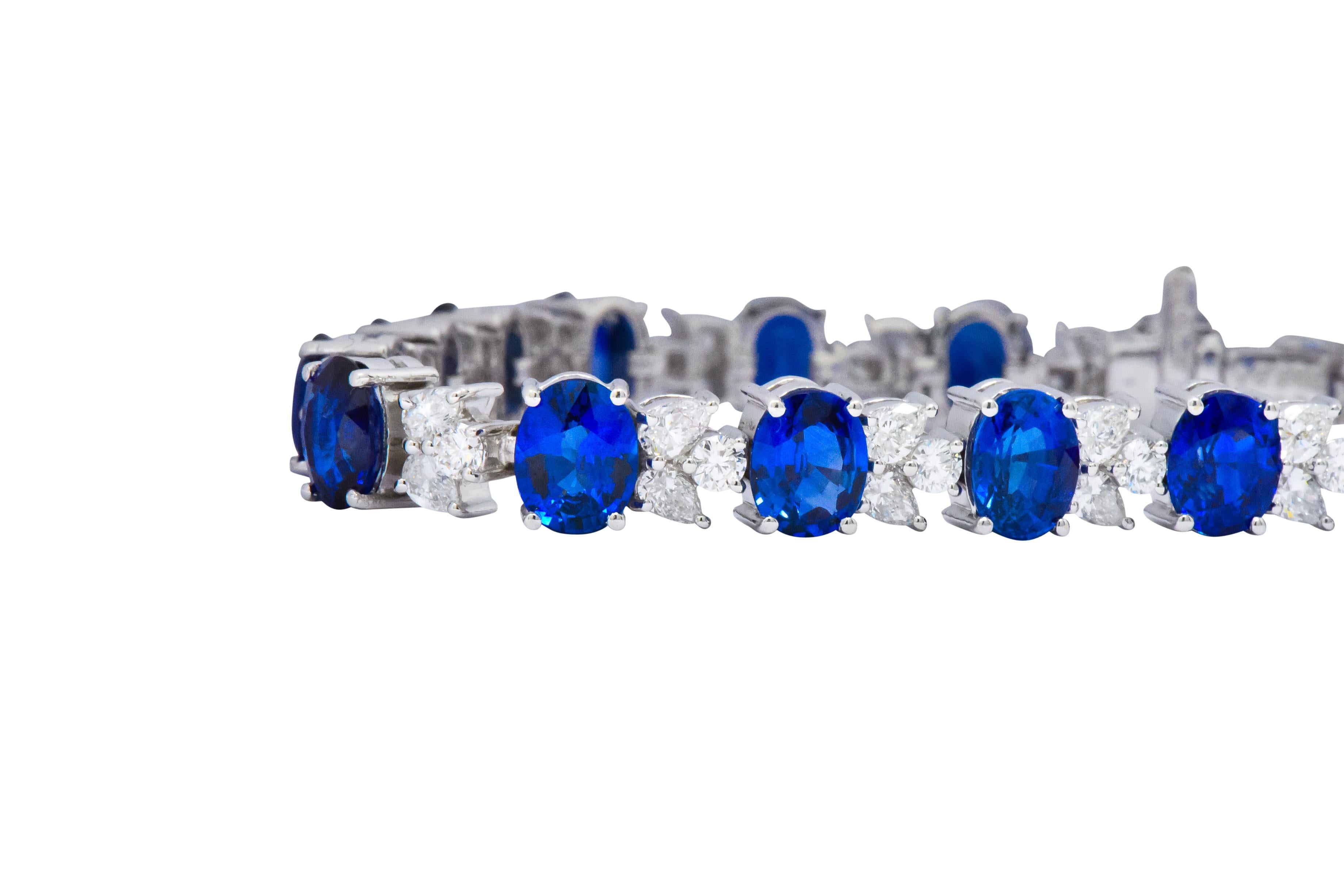 Set with 17 oval cut sapphires weighing 22.82 carats total, rich. bright blue and well matched

Accented with 51 pear shaped and round brilliant cut diamonds weighing 4.38 carats total, G/H color and VS to SI clarity

The mix of pear and round cut