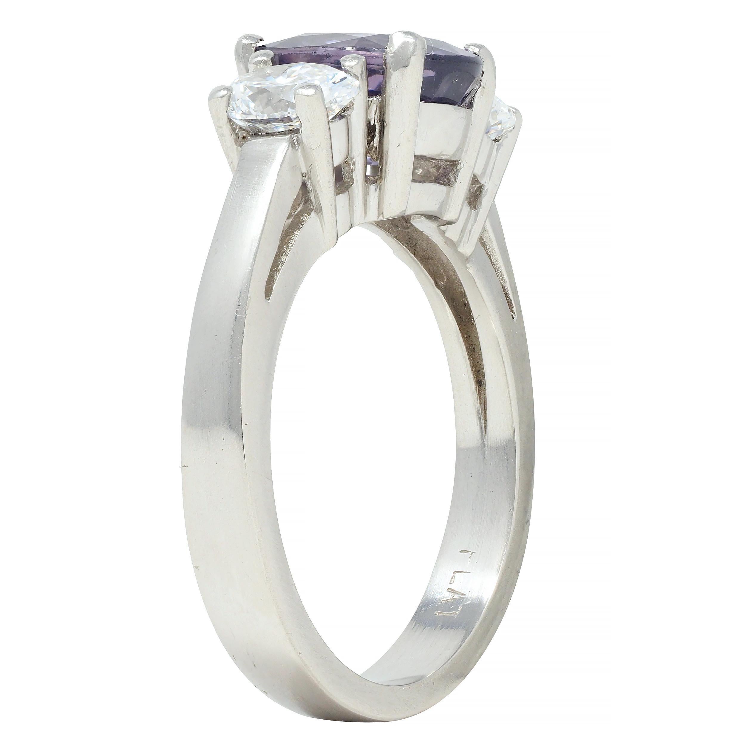 Centering an oval cut spinel weighing approximately 1.92 carats total - transparent medium pinkish purple 
Prong set in basket and flanked by oval cut diamonds 
Weighing approximately 0.86 carat total - G color with VS2 clarity
Prong set in basket