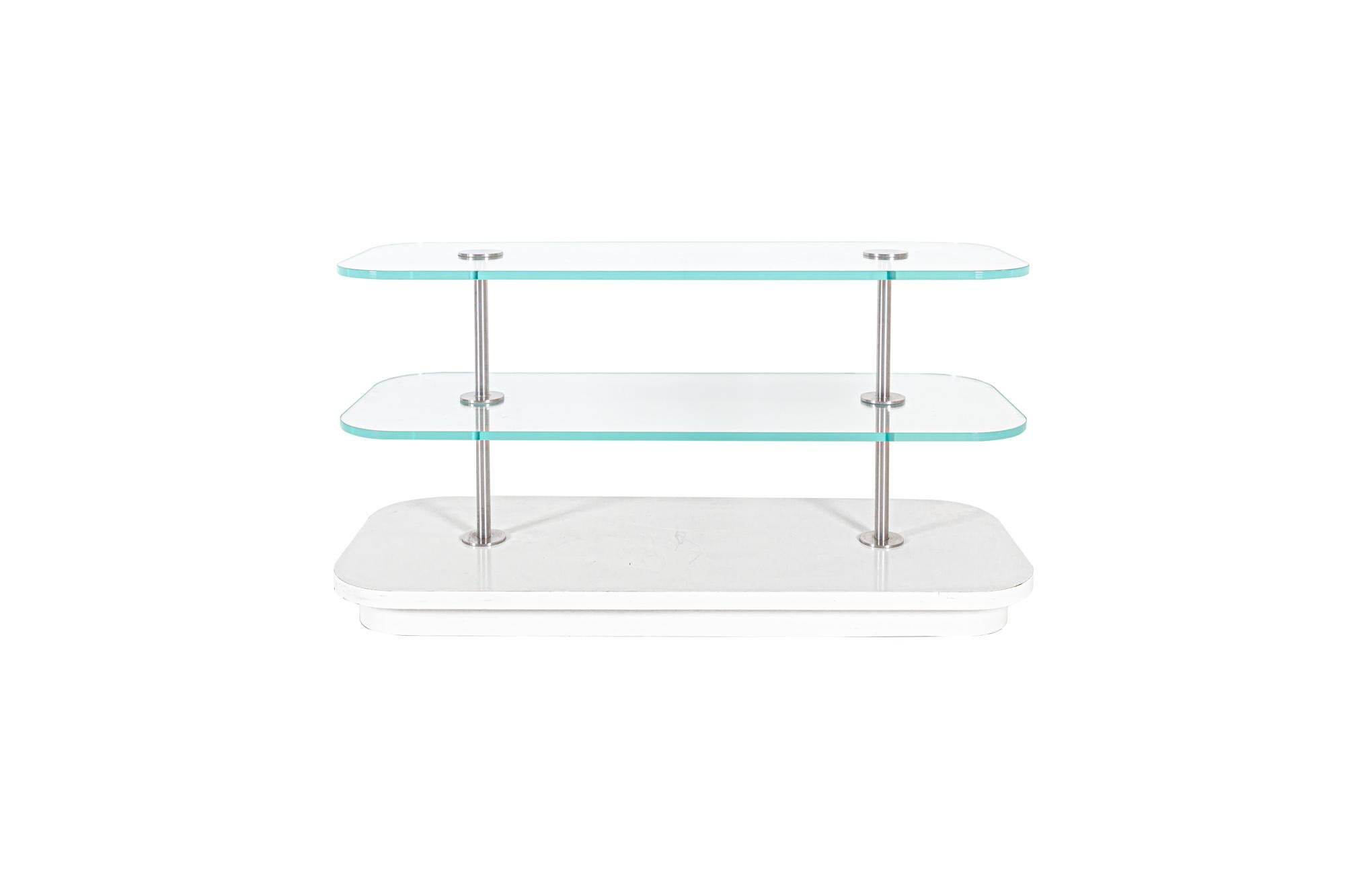 Contemporary 3-tier laminate stainless and glass display

This display shelf measures: 58 wide x 22 deep x 30 inches high

This piece came from Barney's Chicago Retail Store and is in Good Vintage Condition - with some damage to one side of the