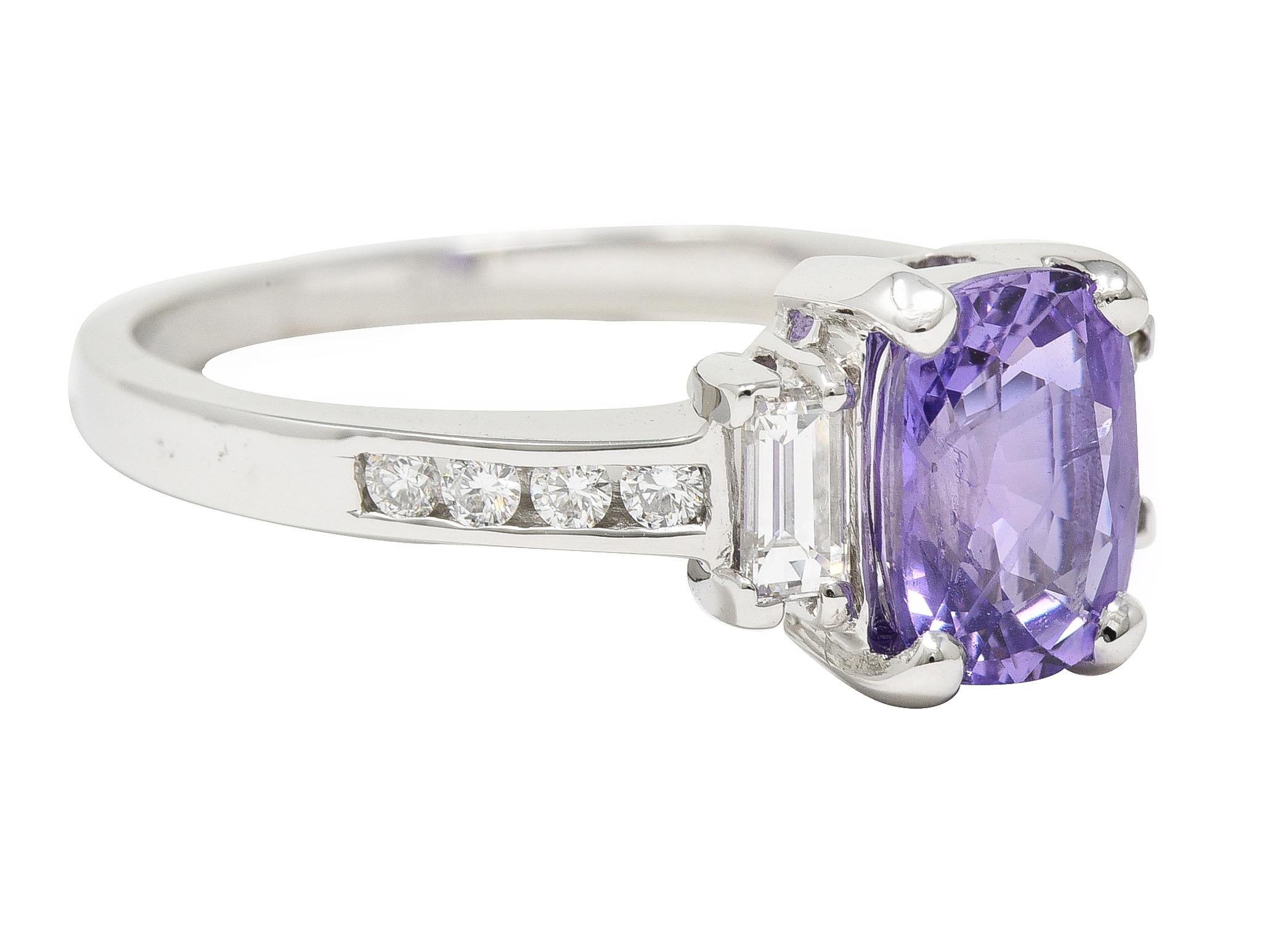 Centering a rectangular cushion cut sapphire weighing 2.68 carats
Natural Sri Lankan in origin with no indications of heat treatment
Transparent light pinkish-purple in color - prong set in basket
Flanked by prong set baguette cut diamonds
With