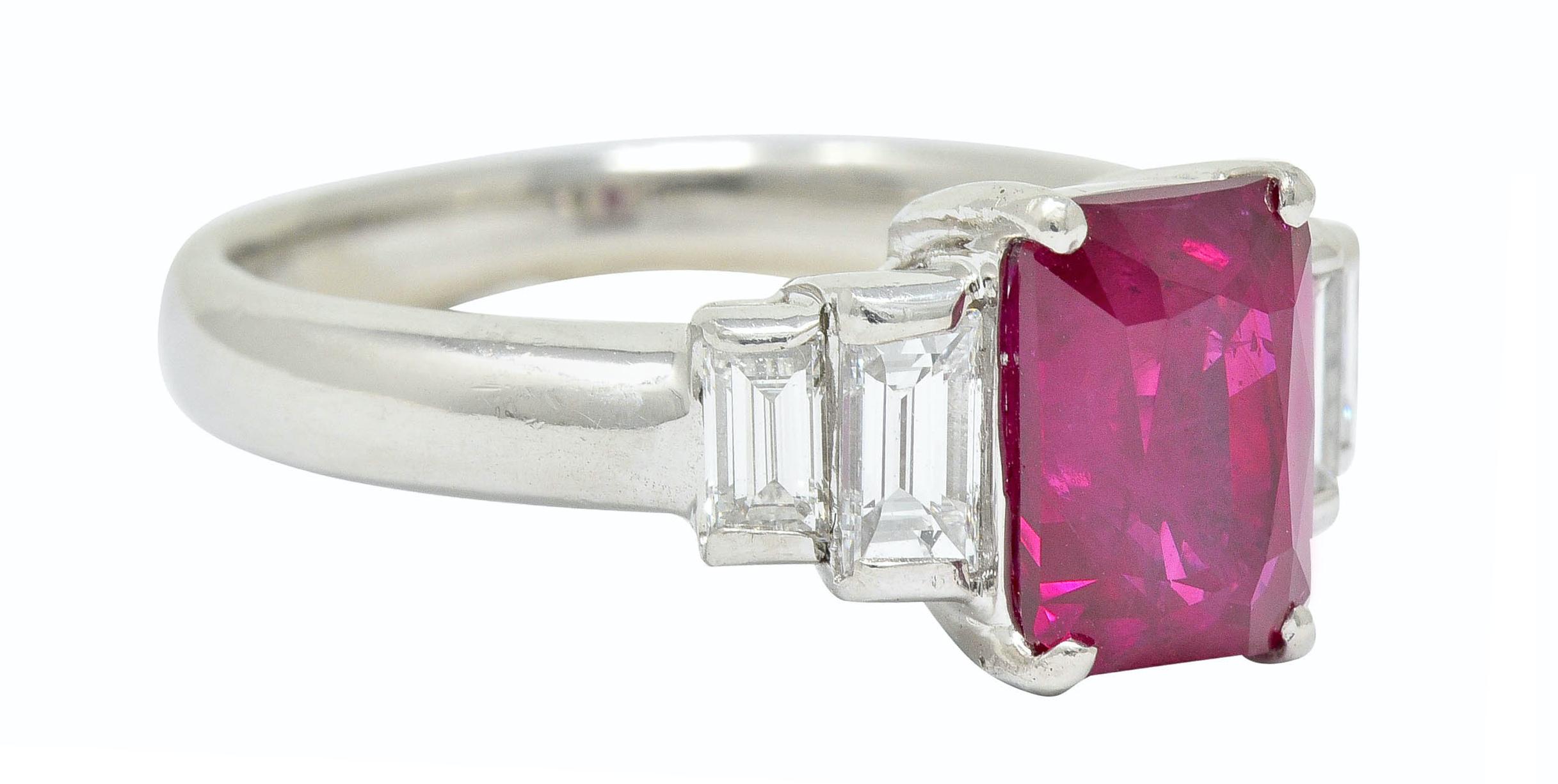 Centering a uniquely cut octagonal Burma ruby weighing 2.78 carats

Transparent with very slightly purplish to bright red color

Flanked by stepped shoulders bar set with baguette cut diamonds weighing in total 0.71 carat; G/H color with VS