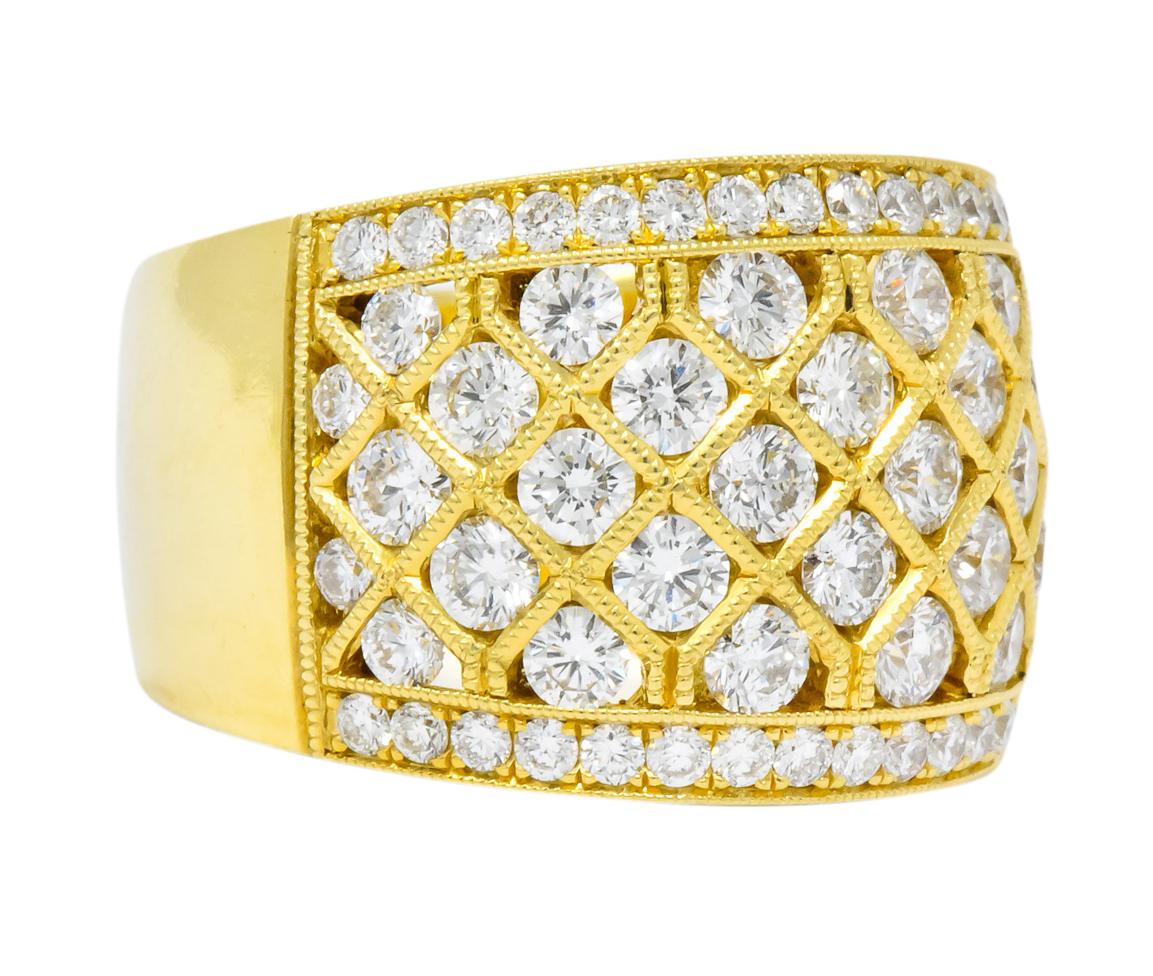 Wide band ring designed as a harlequin motif with milgrain detailing

Set throughout by round brilliant cut diamonds weighing in total approximately 3.50 carats; G/H color with VS to SI clarity

Stamped 18K for 18 karat gold

Ring Size: 11 & sizable
