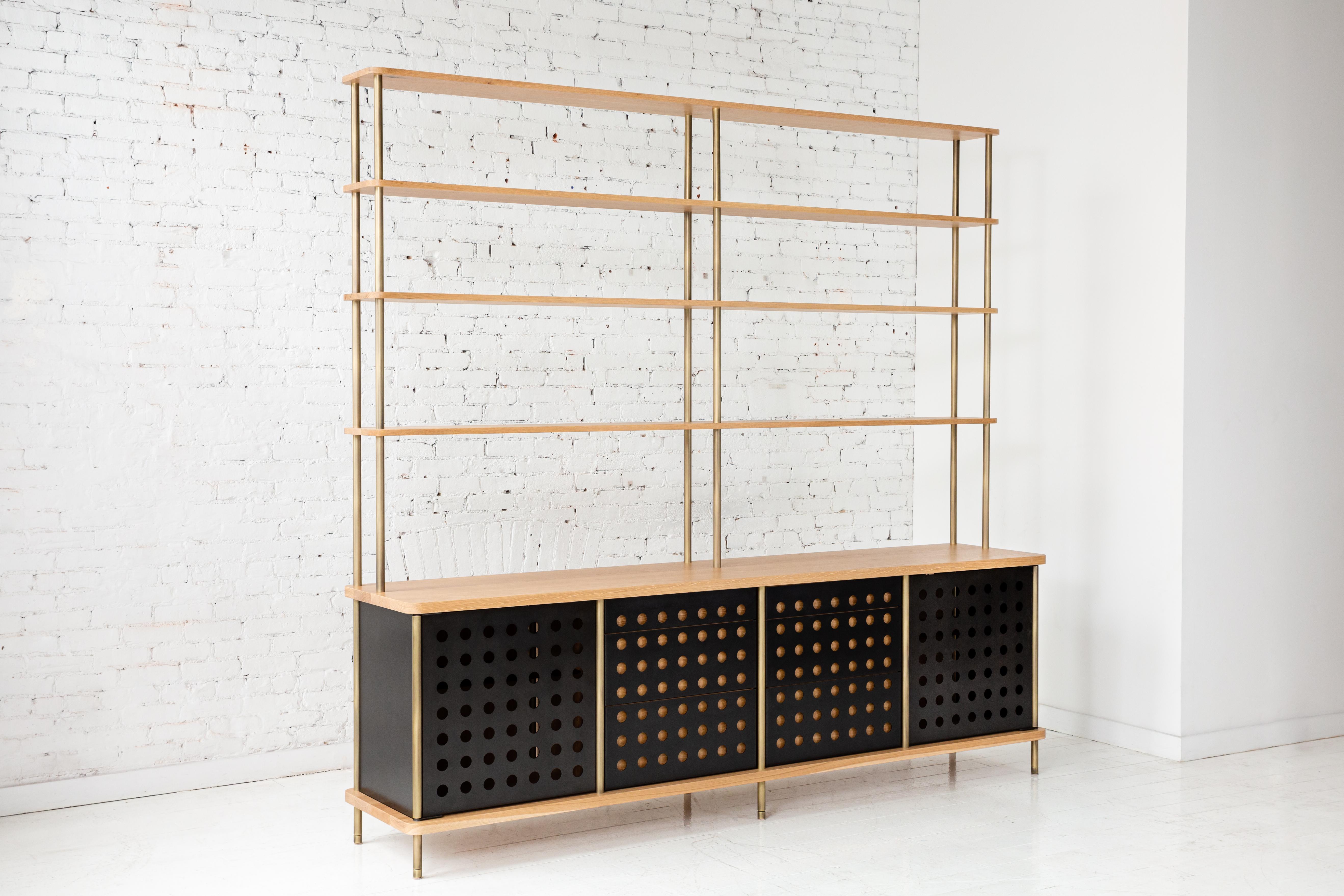Consistent with the Strata collection, the new Strata sideboard is designed to be modular in order to create versatile configurations tailored to your needs. Shown with brass rods, walnut shelving and powder coated aluminum sliding doors, all