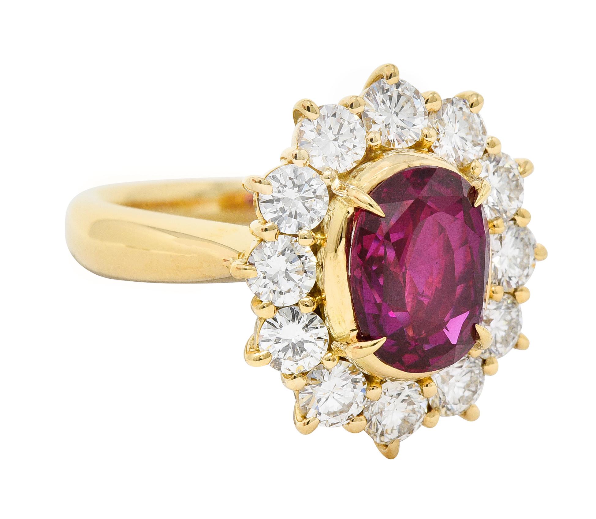 Centering an oval cut ruby weighing 2.86 carats total - natural Vietnamese in origin
Transparent bright medium red in color - set with talon prongs
Featuring a halo surround of round brilliant cut diamonds
Weighing 1.42 carats total - G/H color with