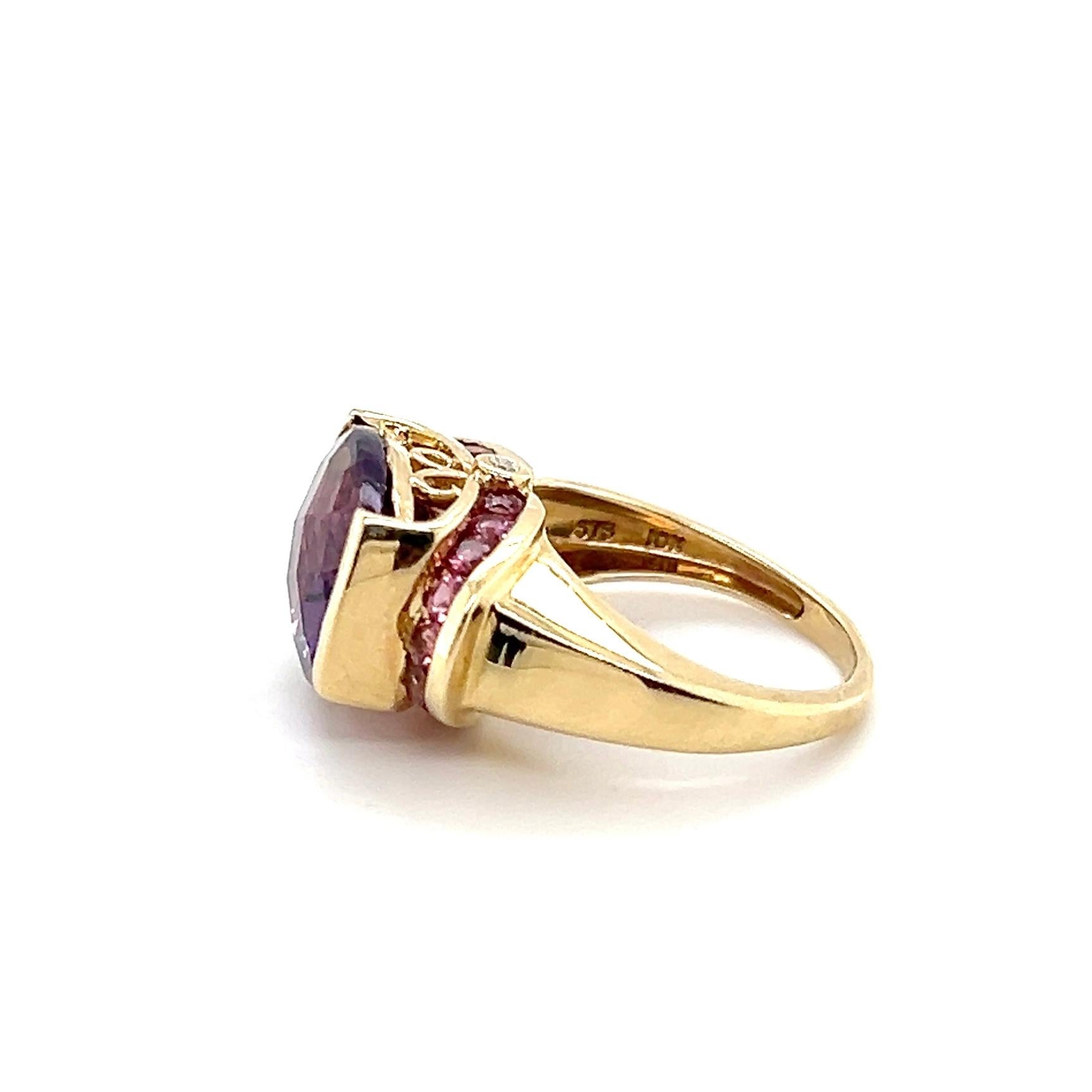 This striking contemporary ring is crafted in 10 karat yellow gold and showcases a bold checkerboard cushion-cut amethyst weighing approximately 5 carats. The richly saturated purple gemstone is beautifully accented by eighteen round-cut pink