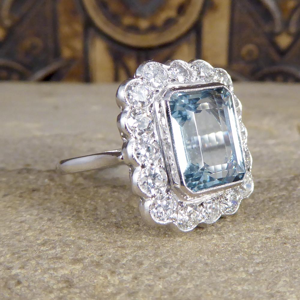 This statement cluster ring holds a 5.00ct Aquamarine in a rub over collar setting with a Diamond surround. With a total Diamond weight of 1.50ct, these modern brilliant cut diamonds create an extra sparkle to this gorgeous Aquamarine gemstone ring.
