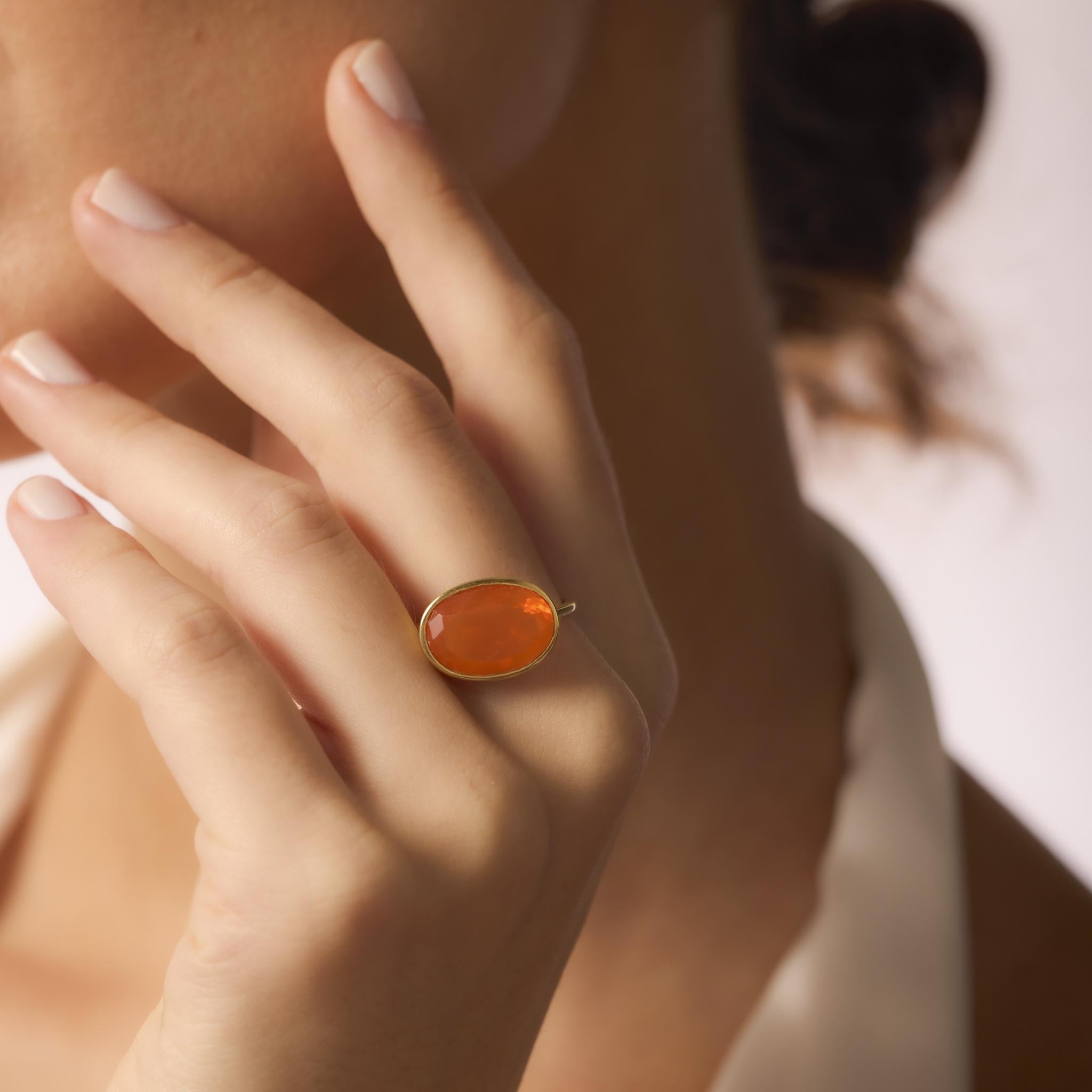 This contemporary Hubert ring showcases a 2.10ct trillion cut fire opal set in rich 18k yellow gold, blending bold geometry with vibrant color.