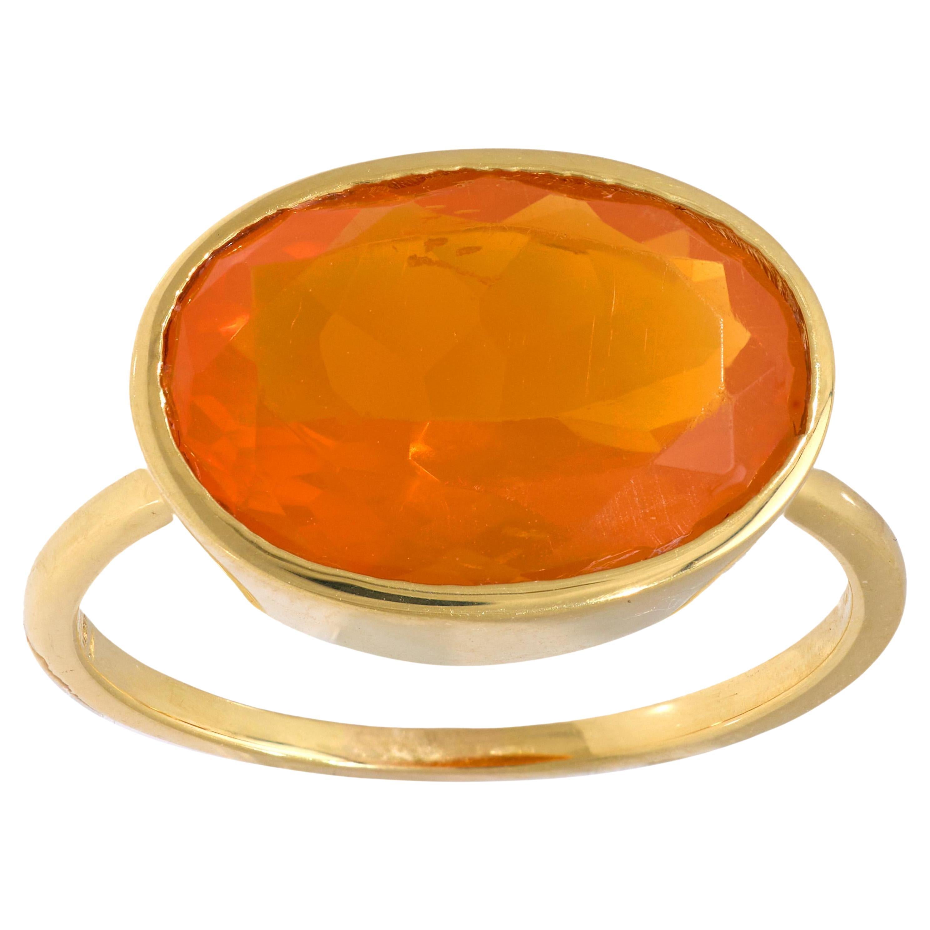 Contemporary 5.50 carat fire opal 18k yellow gold bezel ring For Sale