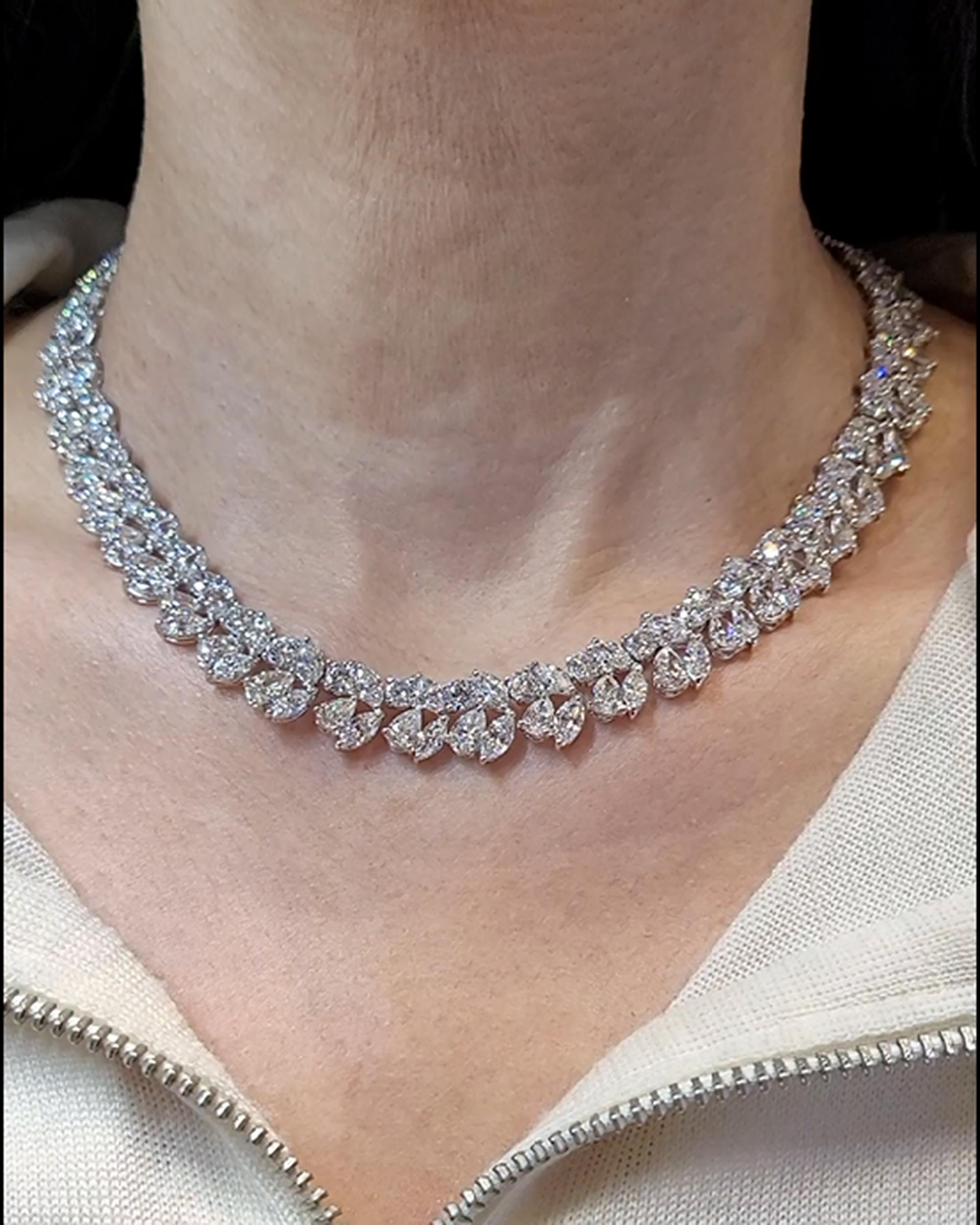 A timeless emblem of luxury, this Contemporary Diamond Cluster Necklace boasts an unparalleled brilliance in its stylized foliate design. Crafted in the 21st century from 18k white gold, this exquisite piece showcases a harmonious blend of marquise,