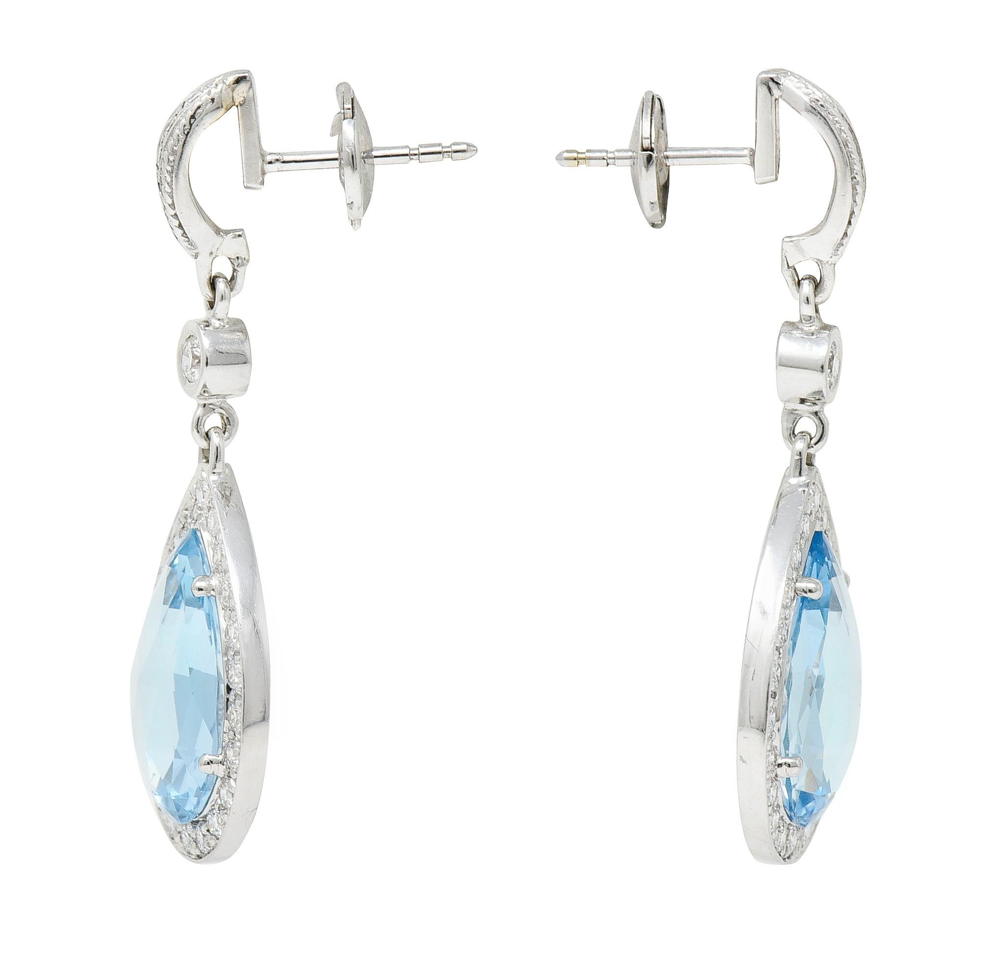 Earrings are designed as a half hoop surmount suspending an articulated drop

Drops feature faceted pear cut aquamarines weighing in total approximately 5.50 carats

Very well matched in medium light and slightly greenish blue color - eye