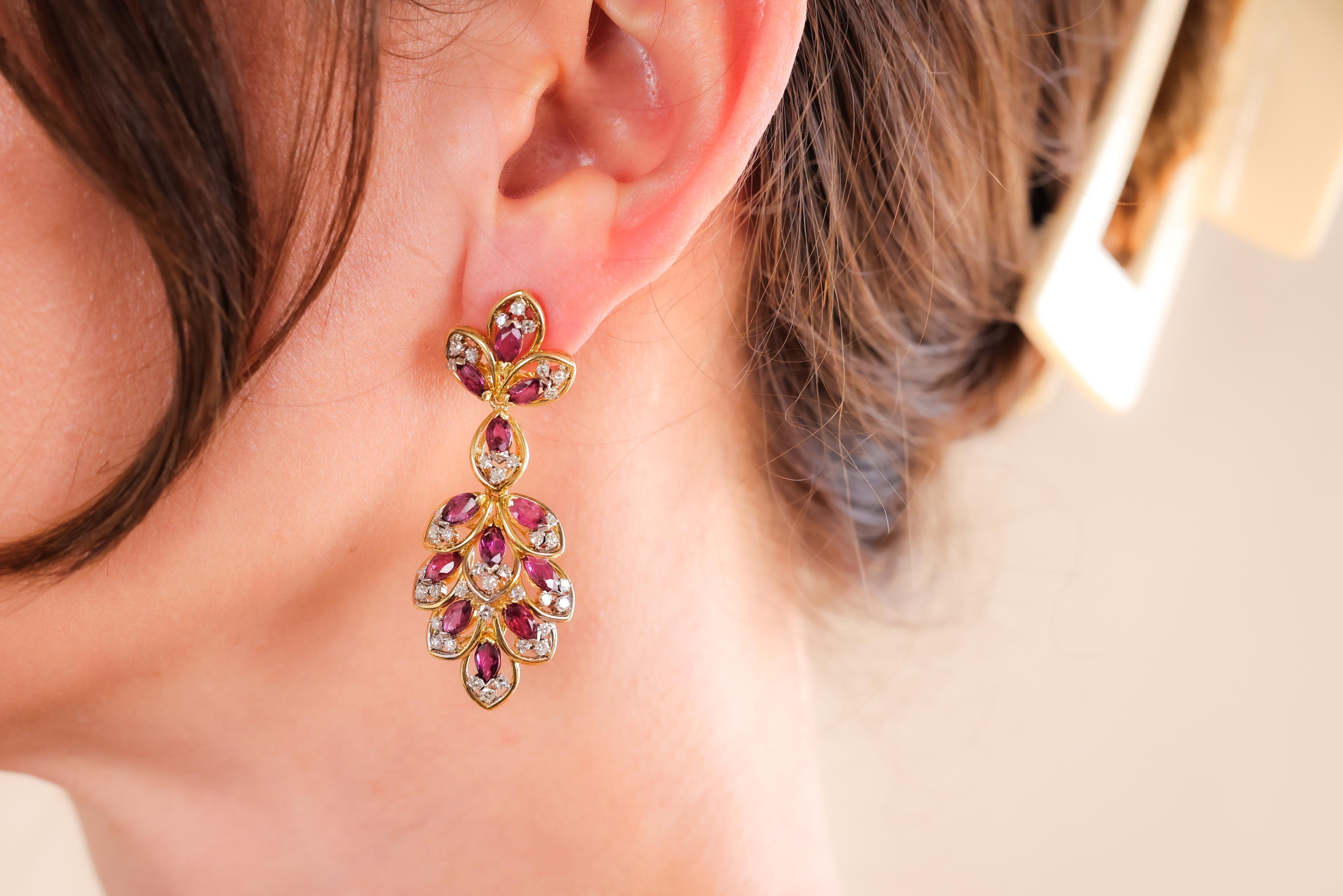Center Stone: 24 Rubies
Cut: Marquise
Weight: Approximately 7.05 Carats
Color: Red
Accent Stone: 78 Diamonds
Cut: Single
Weight: Approximately 1.5 Carats
Color: H
Clarity: VS
Metal: 18K Yellow Gold
Era: Contemporary
Circa: 2000s
Size: 2 1/8 inches