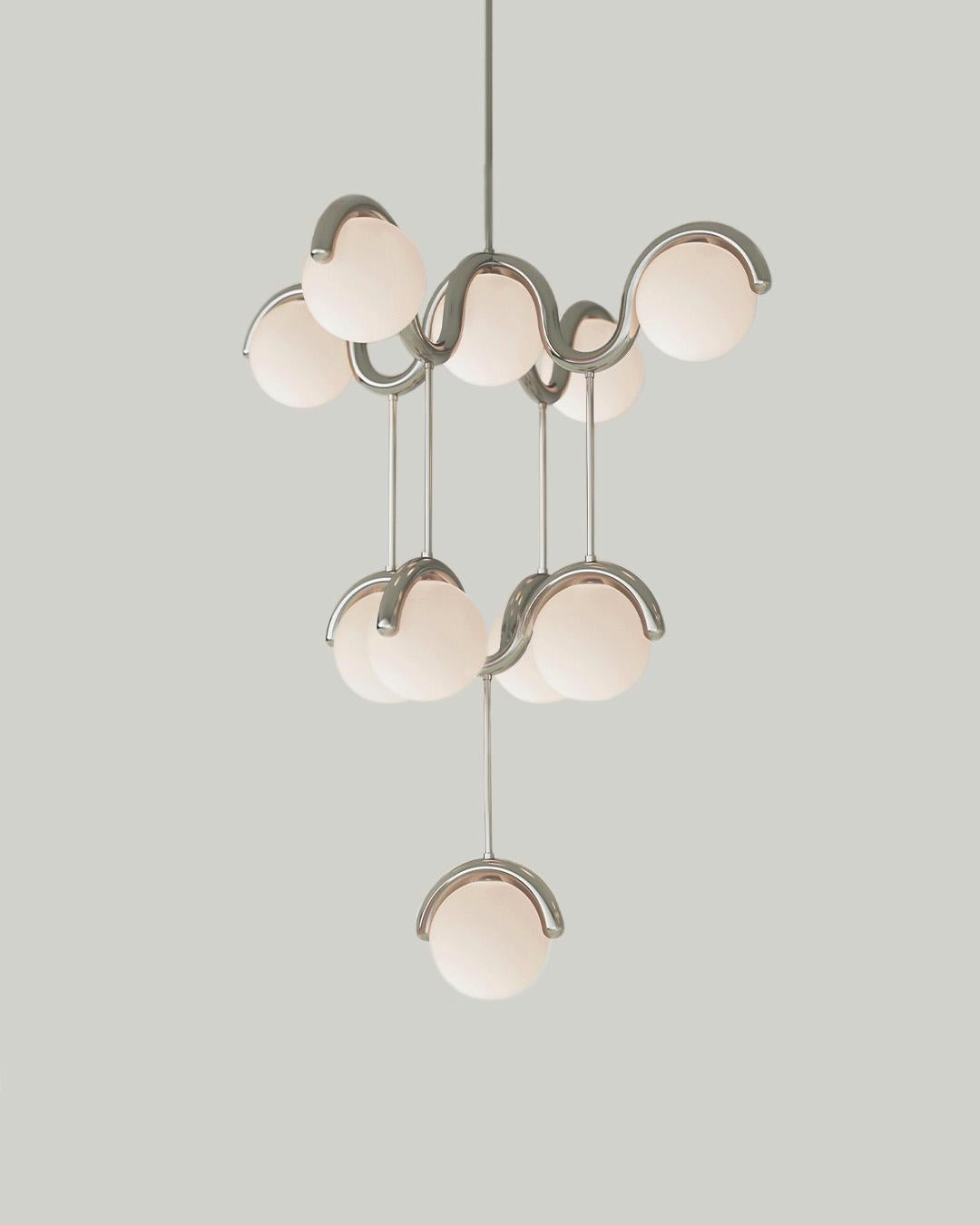 The scalloped design of the Lenox series was inspired by walks through Greenwich Village. A sophisticated and modern take on Art Nouveau, the metal tube bends around the shape of the globe light, creating a flow of movement and synchrony between the
