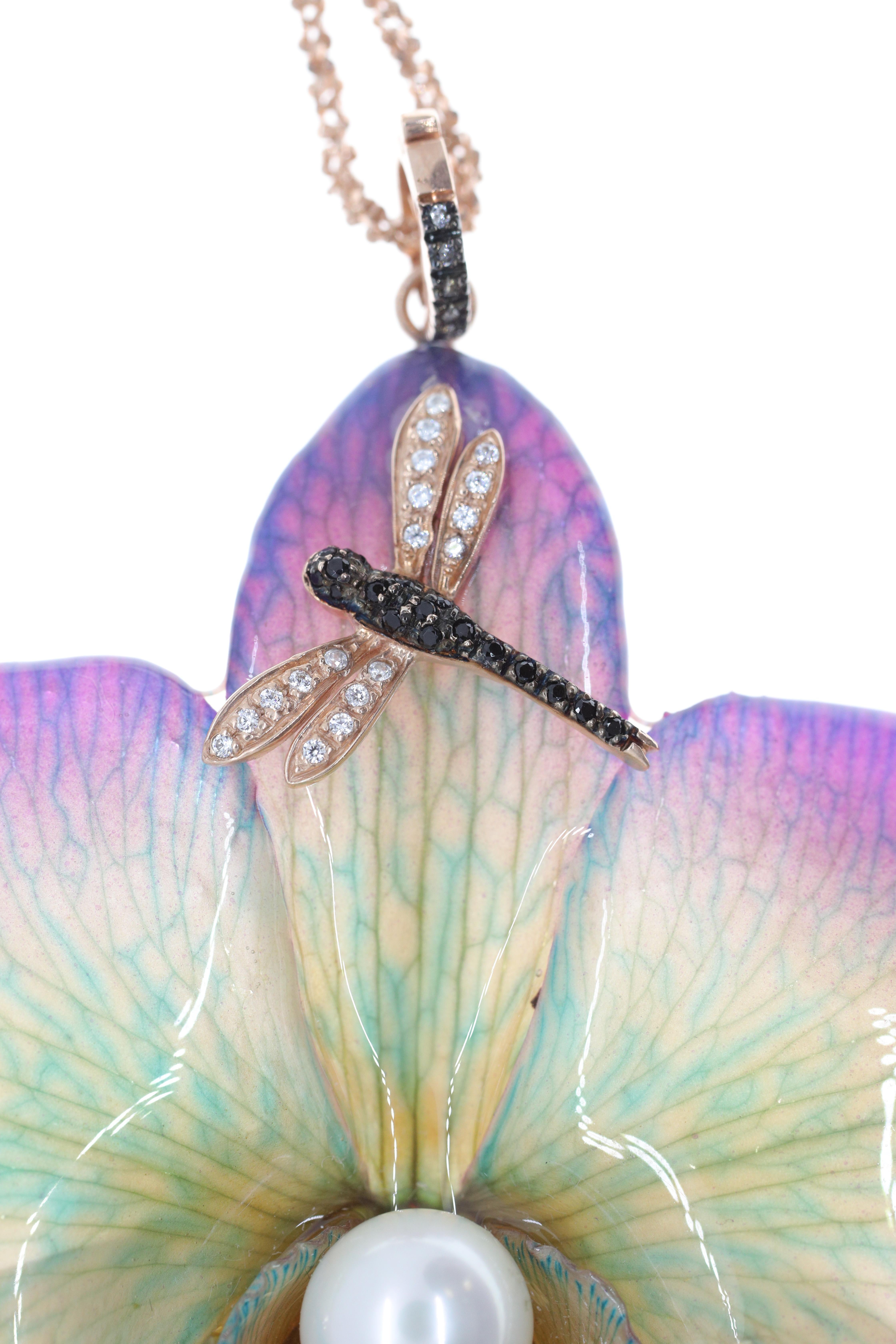 Part jewel, part objet d'art, this pendant was inspired by and made directly from the brilliance and wonder of the natural world. A large, real orchid flower, crystallized at its most glorious moment for eternity hosts a black and white diamond-set