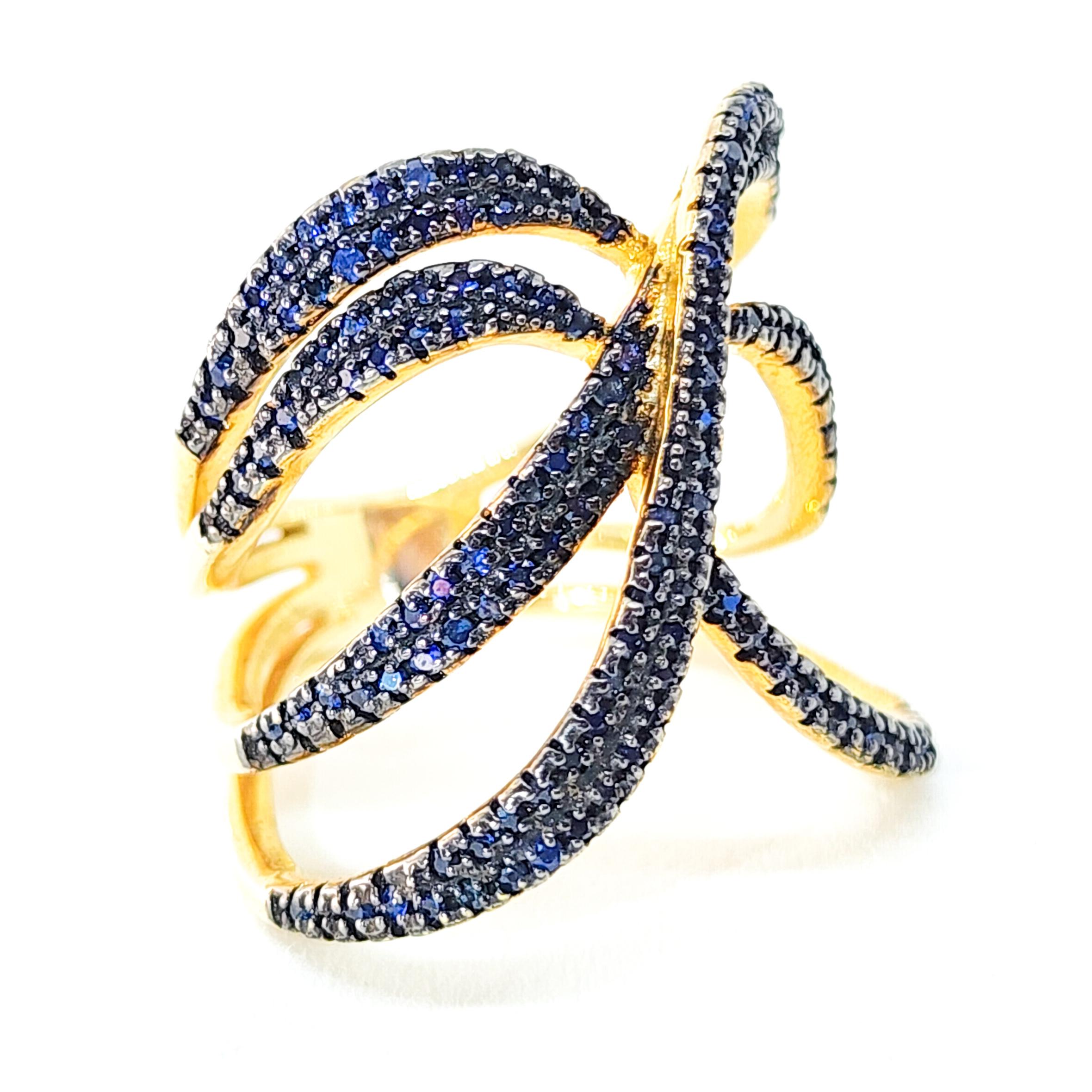 One Bypass, Wrap Around Style Cocktail, Band Ring featuring pave set Blue Sapphires. This festive Ring is an appropriate accent for all seasons wear.  The multi shoulder Ring is a wrap around style Bypass set with 0.95ct of faceted, round Blue