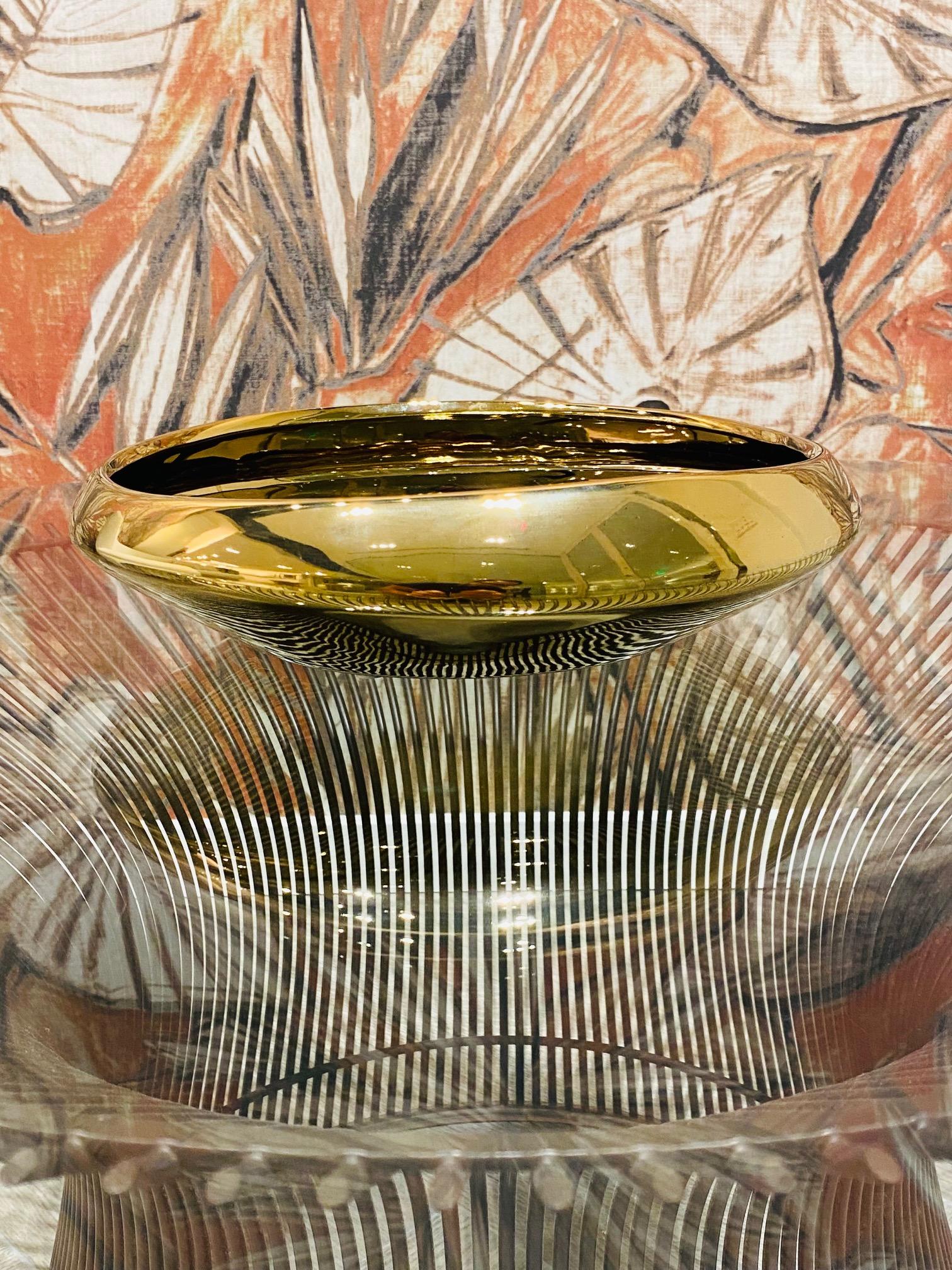 Vintage ceramic centerpiece or decorative bowl featuring an organic abstract form. The ceramic bowl has a beautiful hand-applied reflective gold finish. Reminiscent of Danish Mid-Century Modern design. Stunning from all angles.