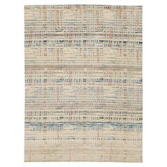 Alfombra de lana tejida a mano con diseño abstracto contemporáneo en tonos neutros terrosos y pasteles