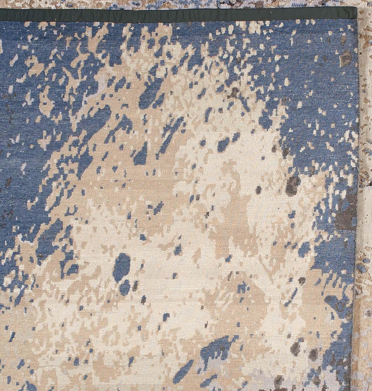This contemporary abstract design features neutral blue, brown, taupe and beige tones in a mix that can provide a stylish base or stand on its own. Hand knotted in India.