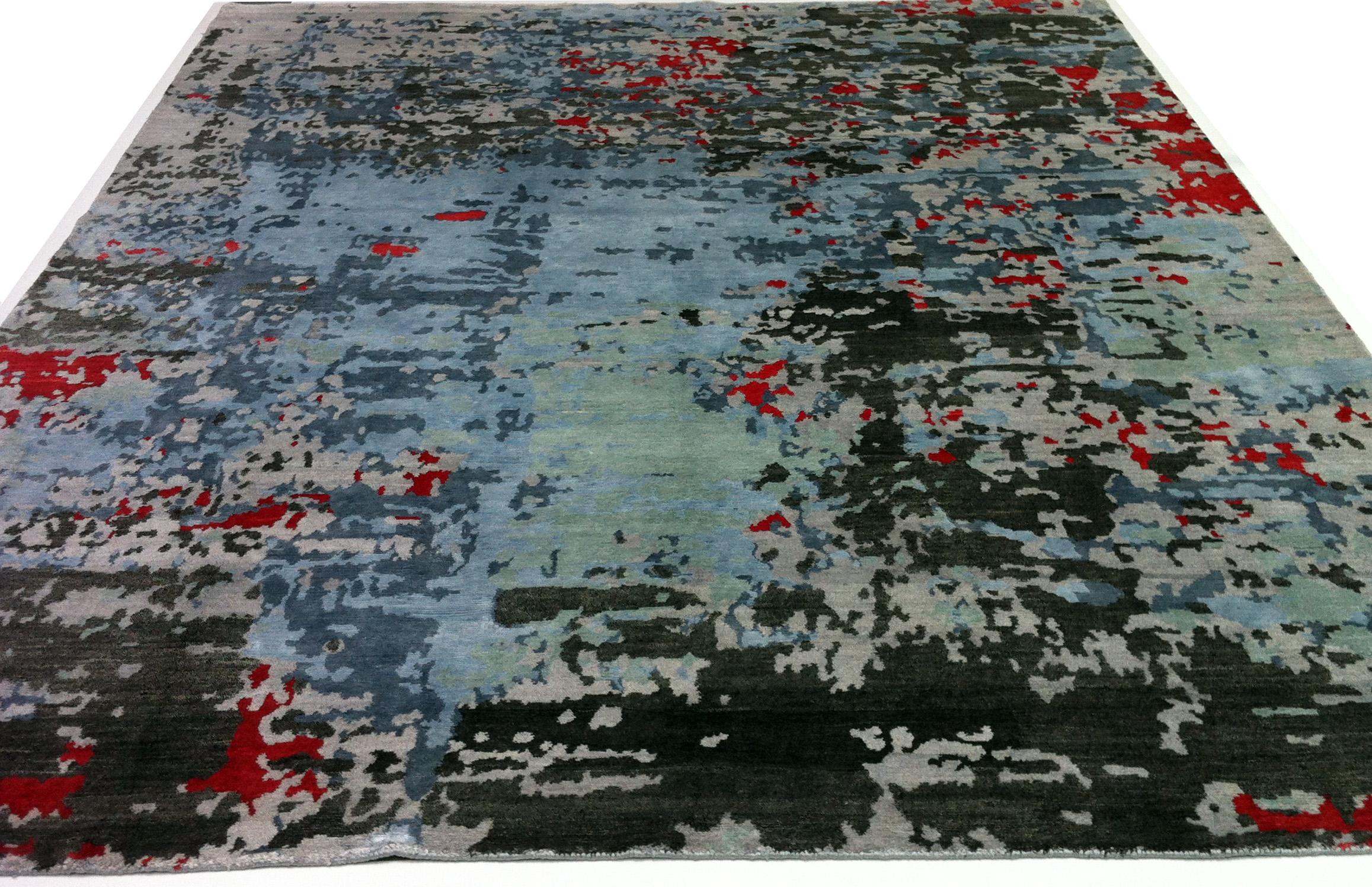Modern colors meet modern design in this hand knotted Indian bamboo silk area rug. Splashes of red enliven the very contemporary light and dark black/grey/silver tones that blend seamlessly.
