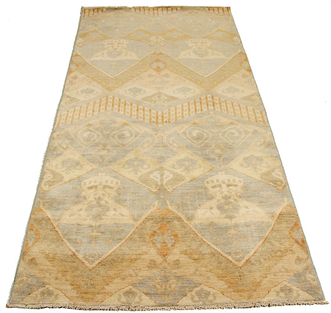 Afghan rug handwoven from the finest sheep’s wool and colored with all-natural vegetable dyes that are safe for humans and pets. It’s a traditional Ikat design featuring a lovely pattern of brown and ivory botanical details on a gray field. It’s a