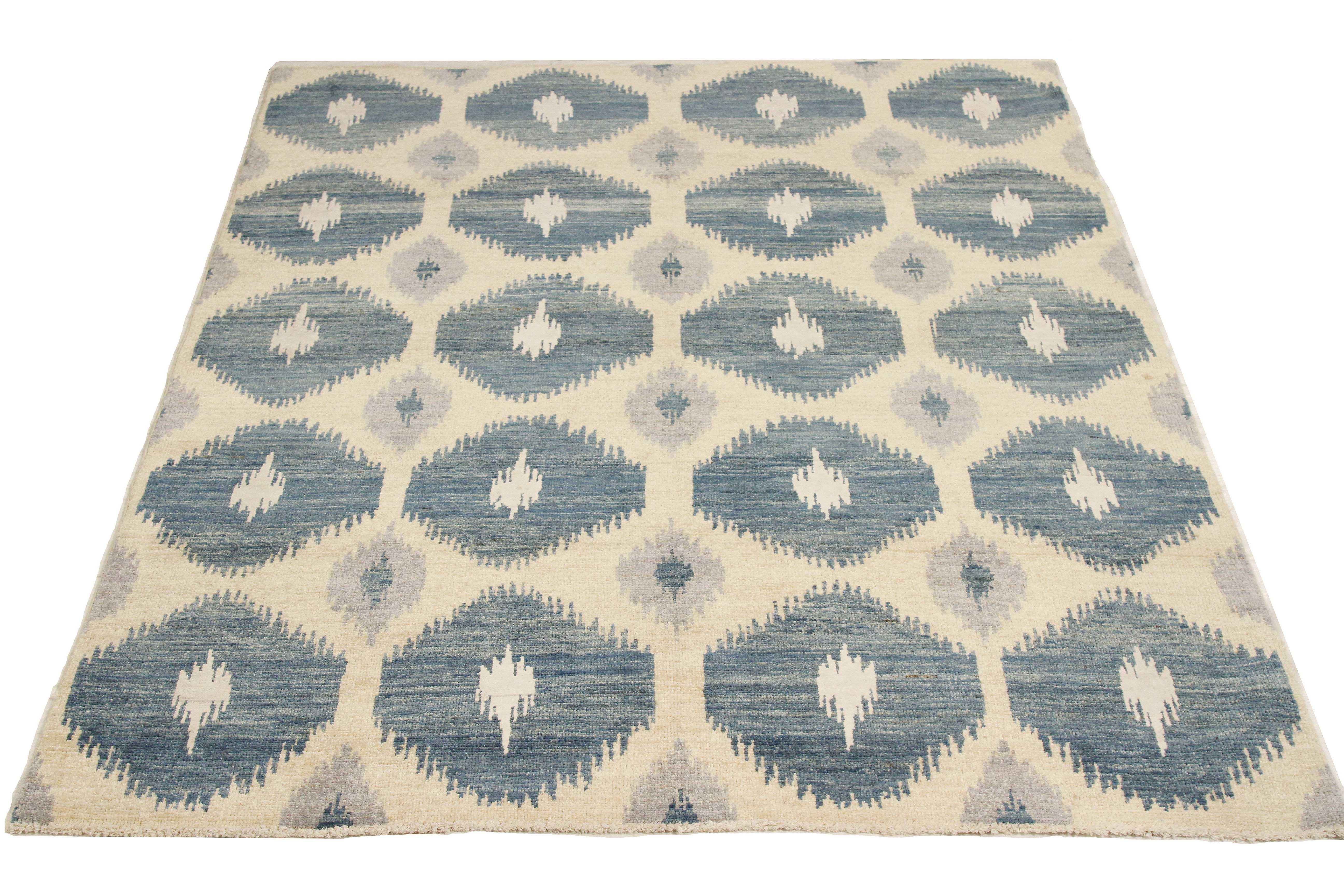 Afghan rug handwoven from the finest sheep’s wool and colored with all-natural vegetable dyes that are safe for humans and pets. It’s a traditional Ikat design featuring a lovely pattern of white and navy hexagonal details on an ivory field. It’s a
