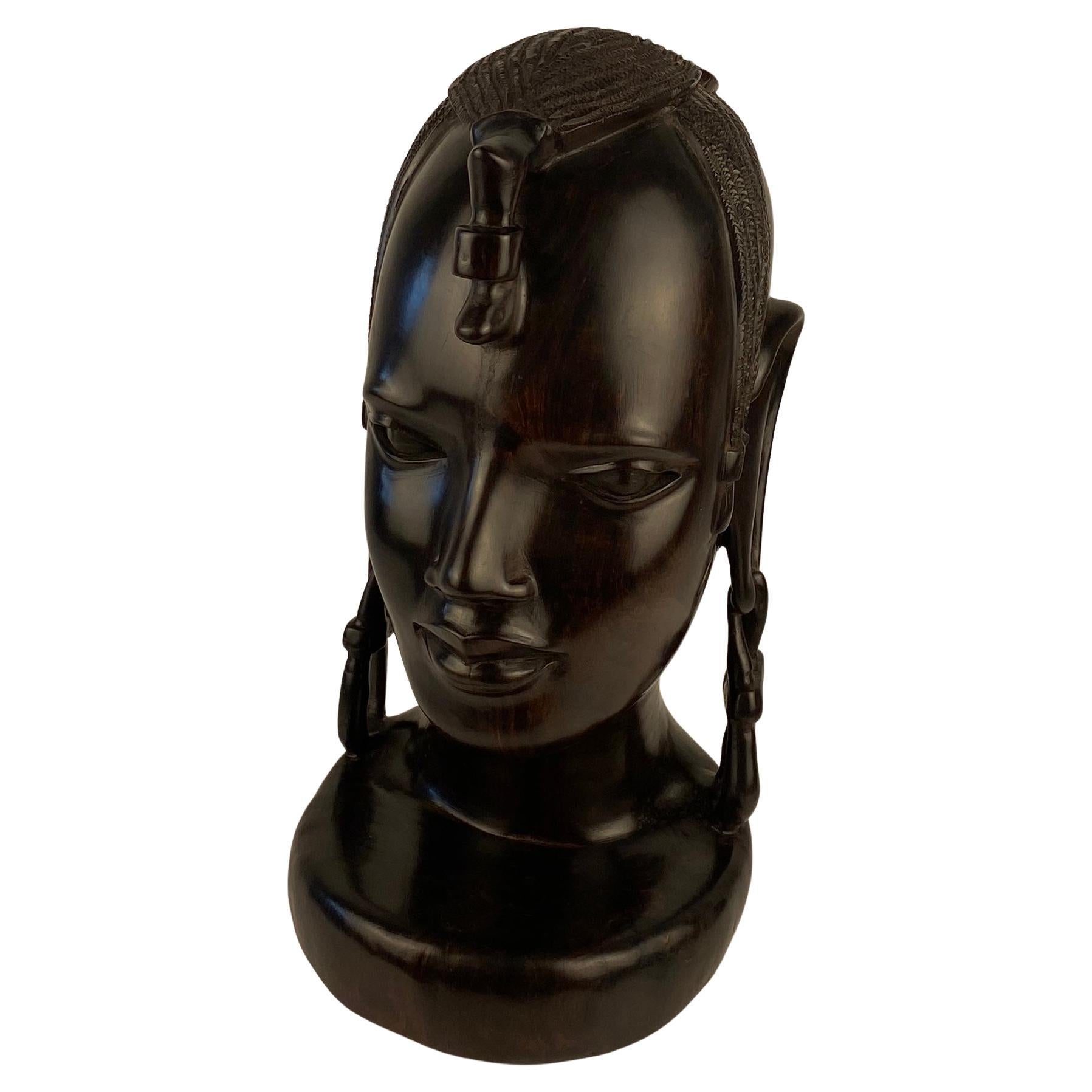 Stunning African Art Sculpture of a Tribal Woman by the Makonde Tribe of Tanzania.

A fine figurative sculpture is made of ebony. This decorative piece of African art is truly eye-catching and has exquisite details. Carved by artist from the Makonde