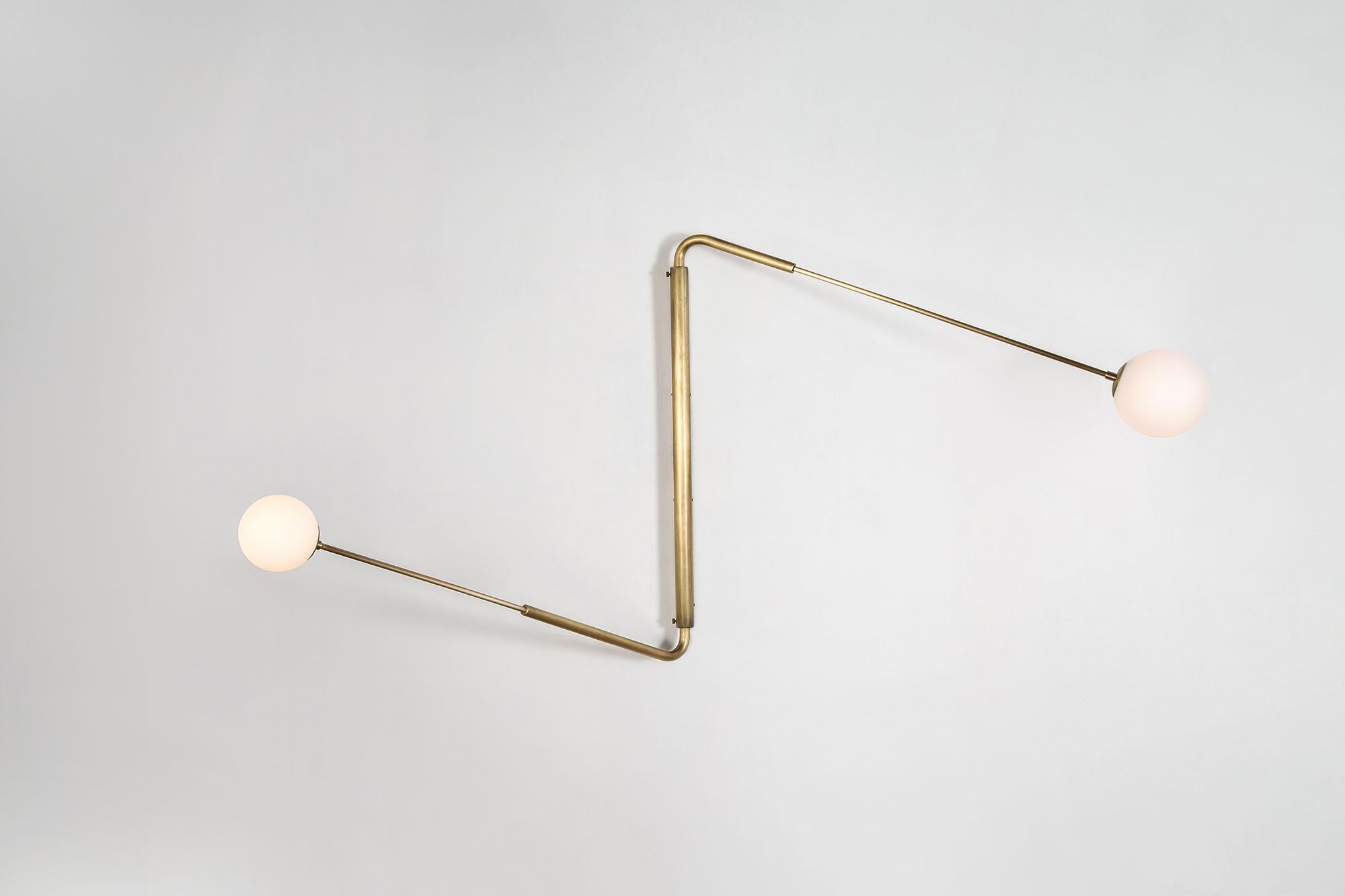 Contemporary Aged Brass Swing Arm Wall Sconce, Flutter Two by Paul Matter

The long rotating arms are attached to a vertical, wall-mounted spine that results in a Minimalist yet oversized fixture. Flutter comes in three variations, each with two