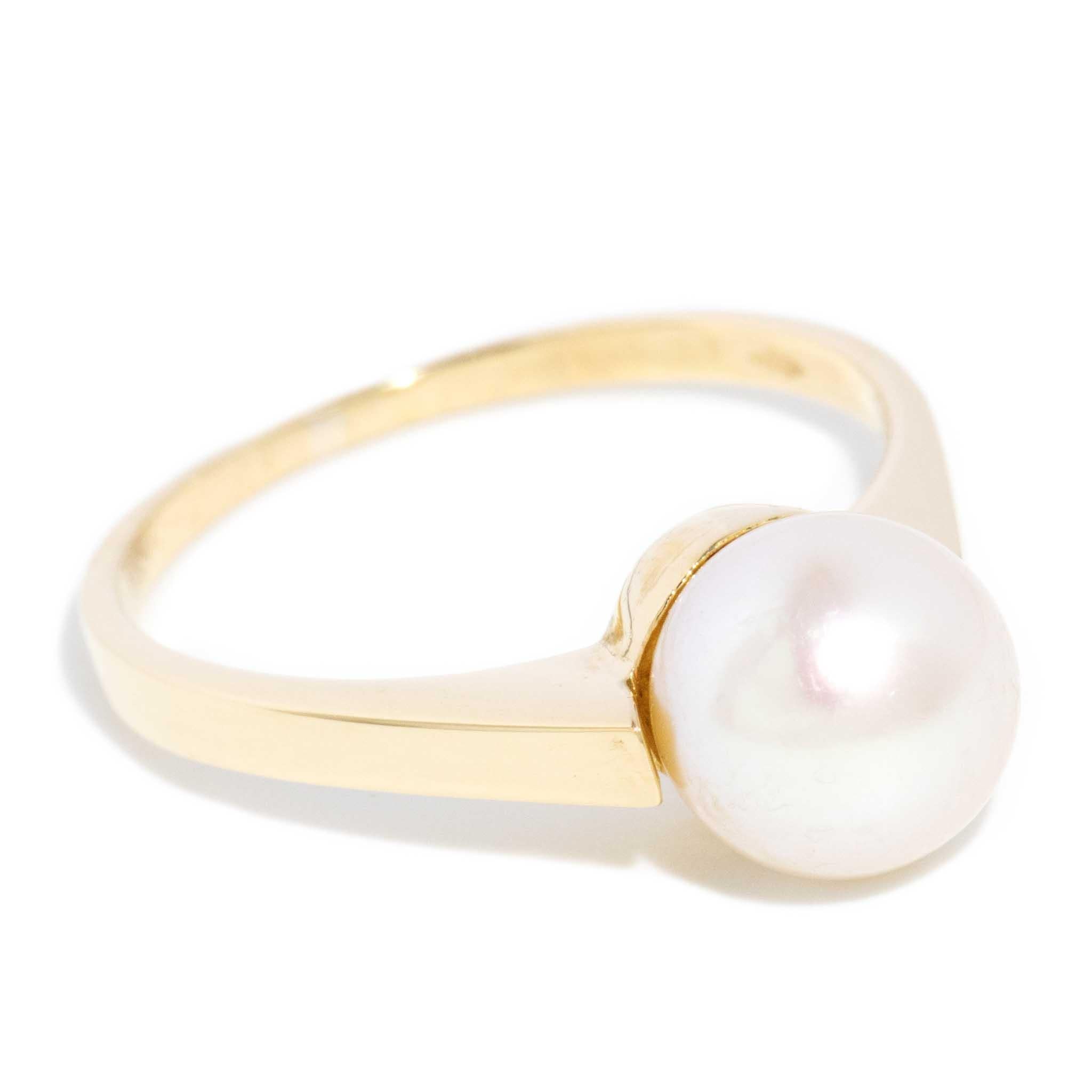 A single satiny pearl, cradled in a band of 18 carat yellow gold, makes our Celina Ring. Her pearl, a soft, iridescent sphere, is framed by the smooth, flowing lines of her yellow gold band, creating a jewel of grace and refinement.

The Celina Ring