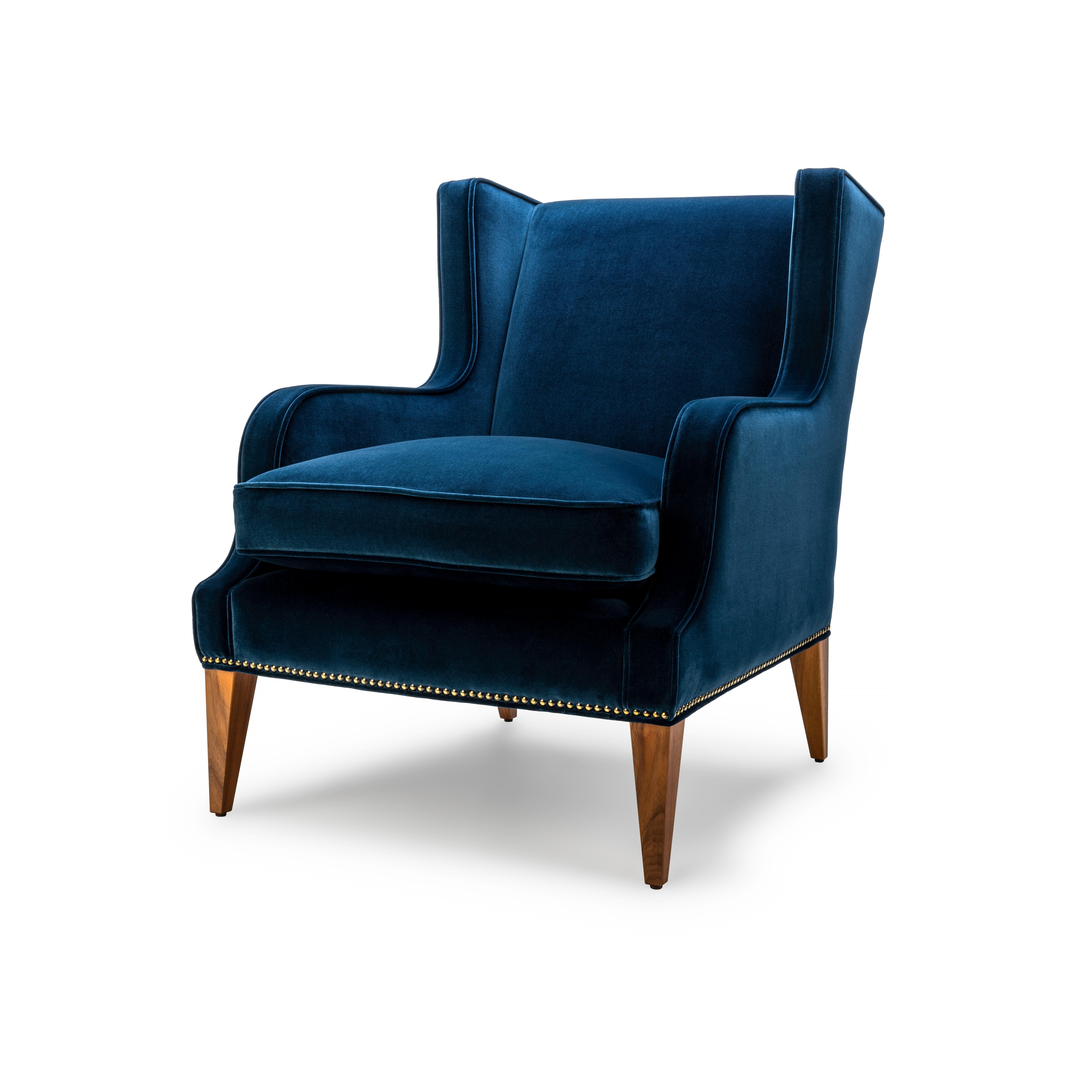 The Alae is available as a wing or lounge chair and features sleek sculptural lines. The seat is softened perfectly with a luxurious feather and down wrapped cushion. The Alae lounge chair shown here upholstered in denim cotton velvet with legs in