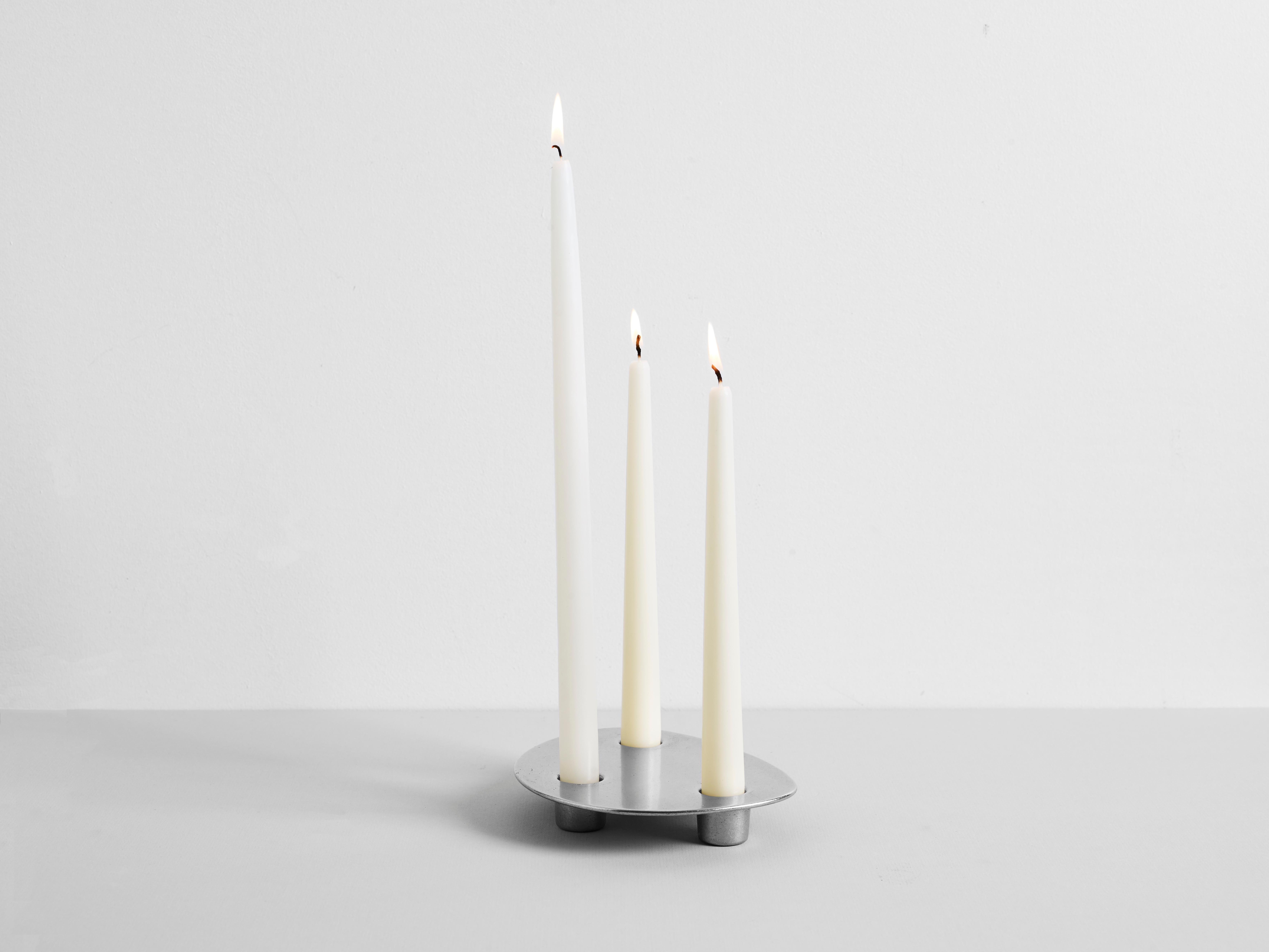 Contemporary aluminium trio candleholder Henry Wilson

Trio holds three candles in a solid, hand poured, brass form. 

Trio candleholder is manufactured in small batches, slight variations will occur from piece to piece. Production marks may