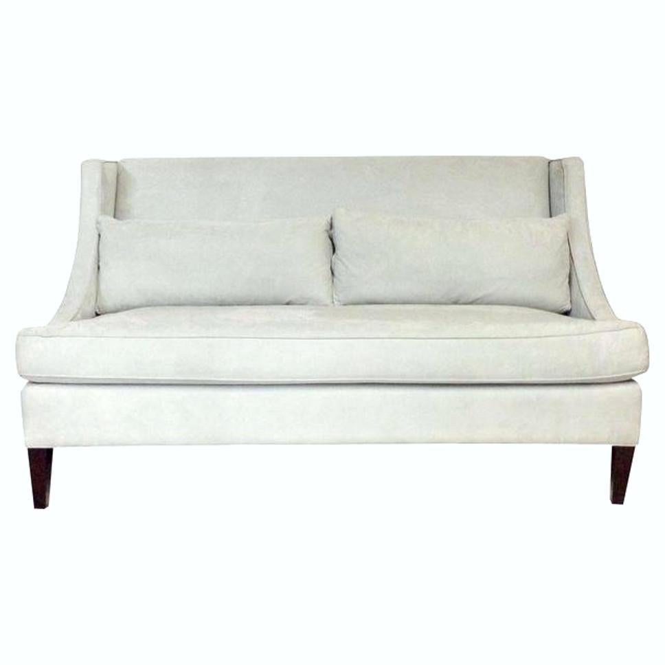 20th Century Transitional suede tufted dove grey self-welt upholstered wing back settee sofa. Features mahogany stained wood legs. Includes two back cushion pillows. Finished on all sides. Seat height, 19.5