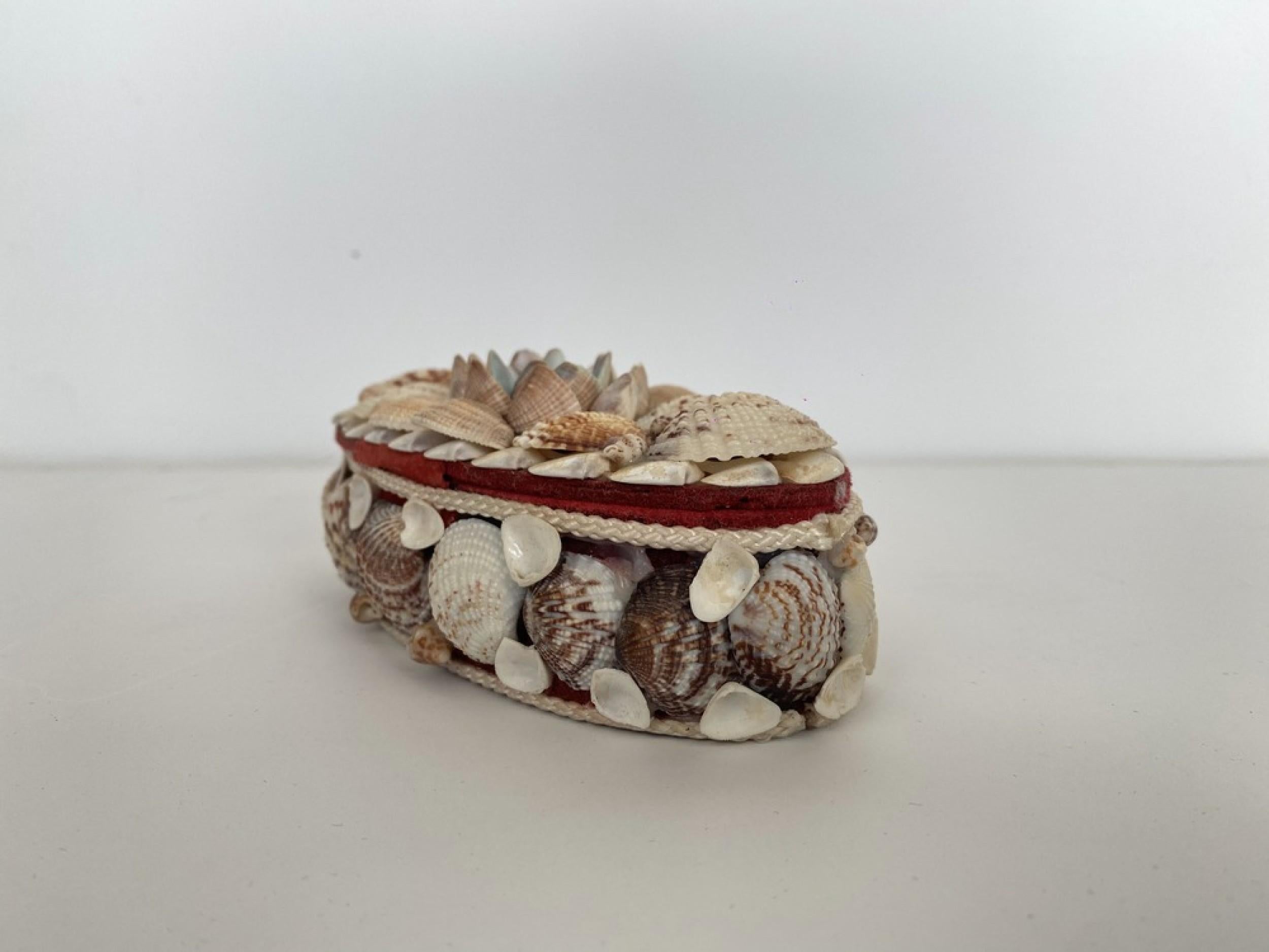 Contemporary American Modern oval jewelry box with an applied seashell exterior and red velvet interior.