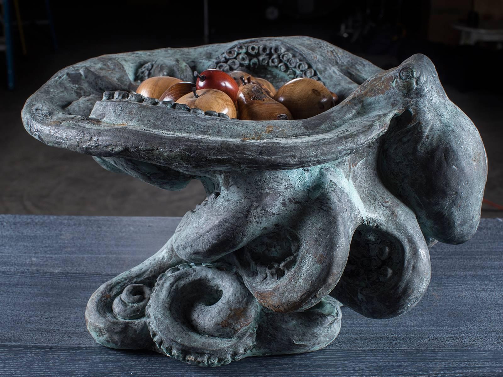 The sensuous curves on this modern American contemporary octopus sculpture reflect the fascinating ocean dweller the octopus. The hand cast octopus is used here to support a large centerpiece bowl sculpture perfect for use on a dining or coffee
