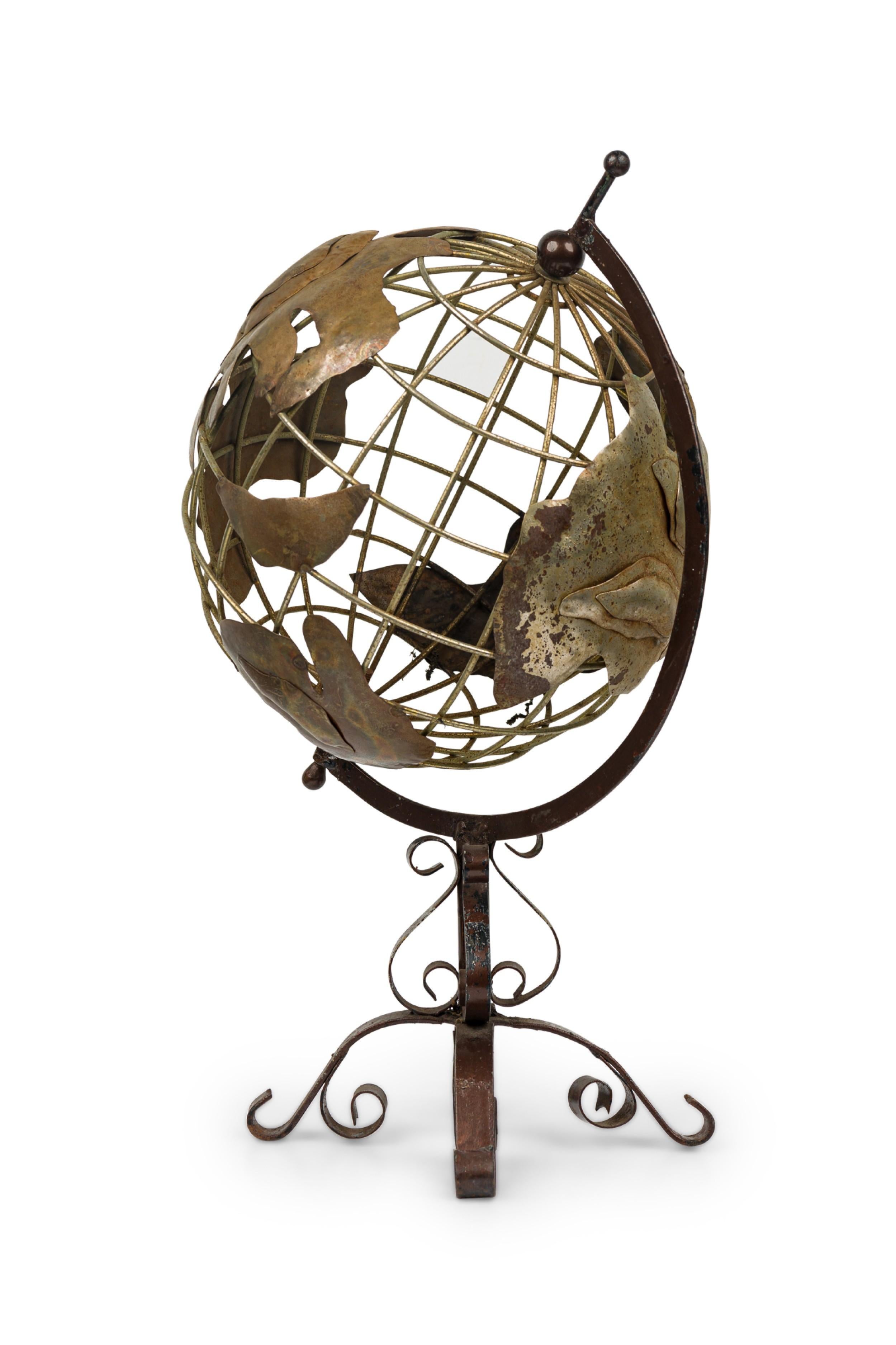Contemporary American openwork metal globe rotates along its axis at a tilted angle, mounted on a scroll form metal stand.
 

 Wear to finish

