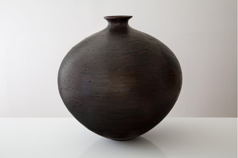 Part of Richard Haining's STACKED Collection, this vase was made using Alaskan Cedar salvaged from a decommissioned NYC water tower. The wood's natural coloring is a pale light blond; although this vase is very dark in its appearance, there is no