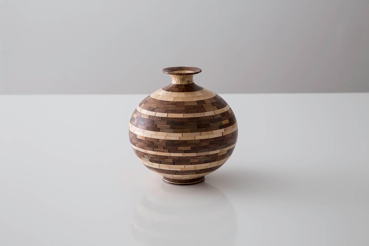 Part of Richard Haining's STACKED Collection, this vessel uses a combination of reclaimed walnut and maple. The salvaged wood offcuts were sourced from a variety of local Brooklyn wood shops. The intentional choice to use two highly contrasting