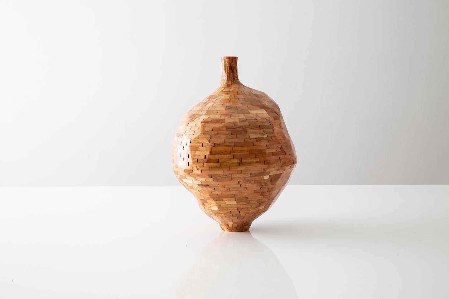 Part of Richard Haining's STACKED Collection, this vase was made using reclaimed cherry sourced and salvaged from a variety of local Brooklyn wood shops. The wood's natural coloring shows off warm tones ranging dark oranges to light browns and reds,