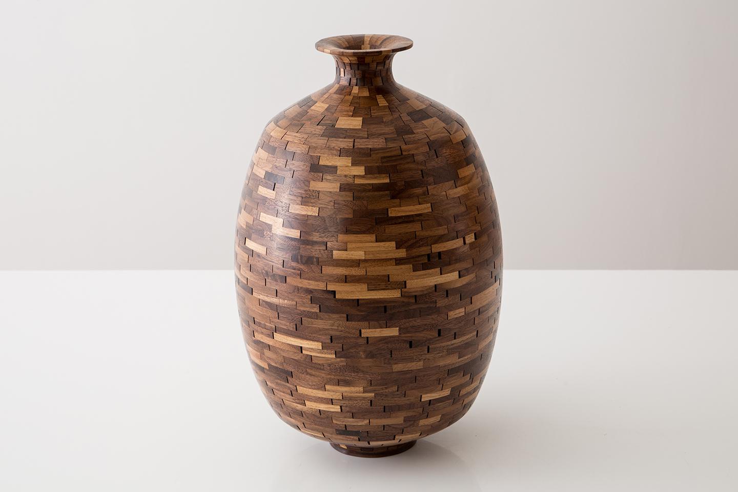 Part of Richard Haining's STACKED Collection, this vessel uses reclaimed walnut. The salvaged wood was sourced from a variety of local Brooklyn wood shops. The wood's natural coloring shows off tones primarily ranging from mid to dark browns with a