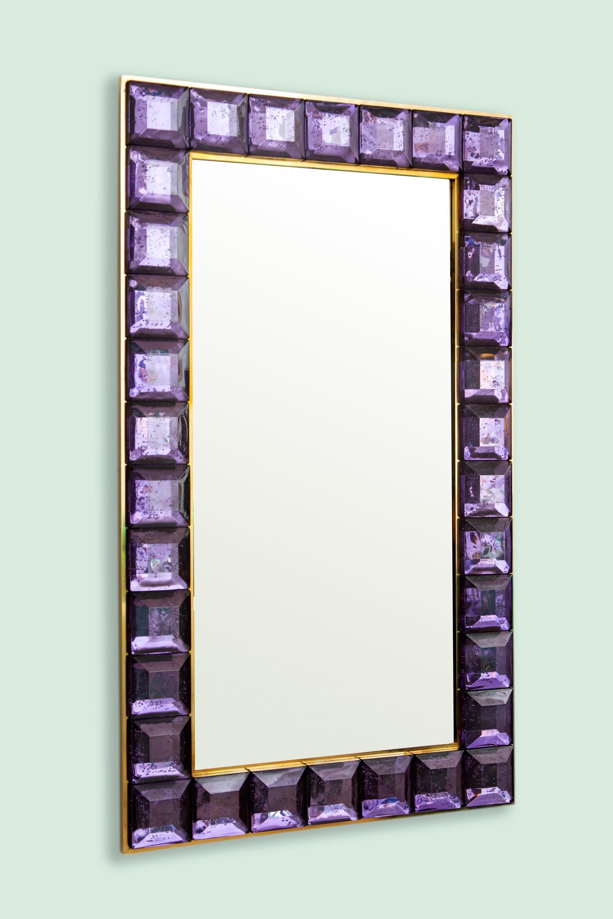 Contemporary amethyst square diamond cut Murano glass mirror (2 available), in stock
Vivid and intense amethyst glass block with naturally occurring air inclusions throughout 
 Highly polished faceted pattern
 Brass gallery
 Luxury handcrafted