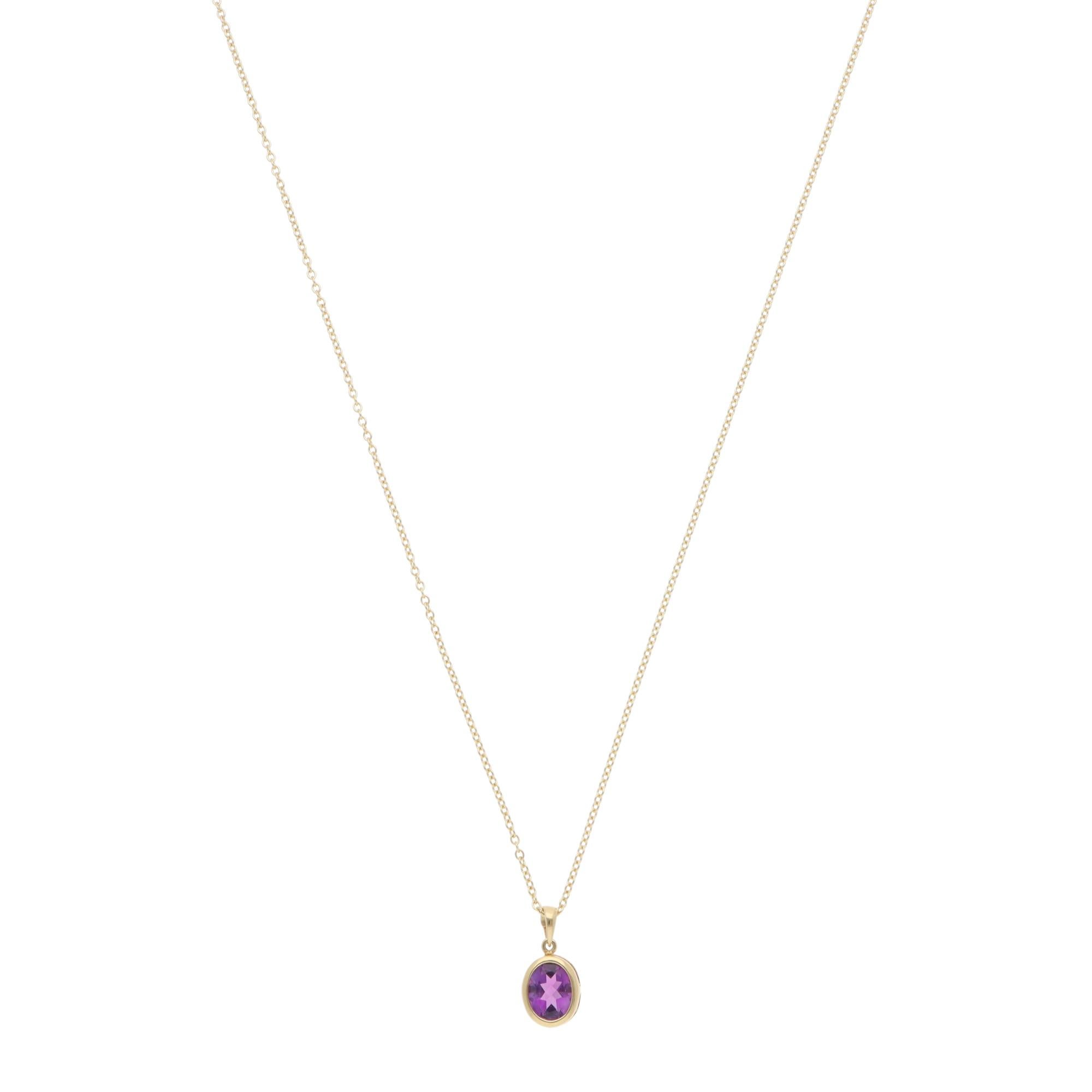 A beautiful contemporary amethyst pendant necklace set in 18k yellow gold.

The necklace solely features a vibrant oval mixed-cut amethyst, which is securely set in an open gallery bezel setting. The true beauty of this piece lies in the