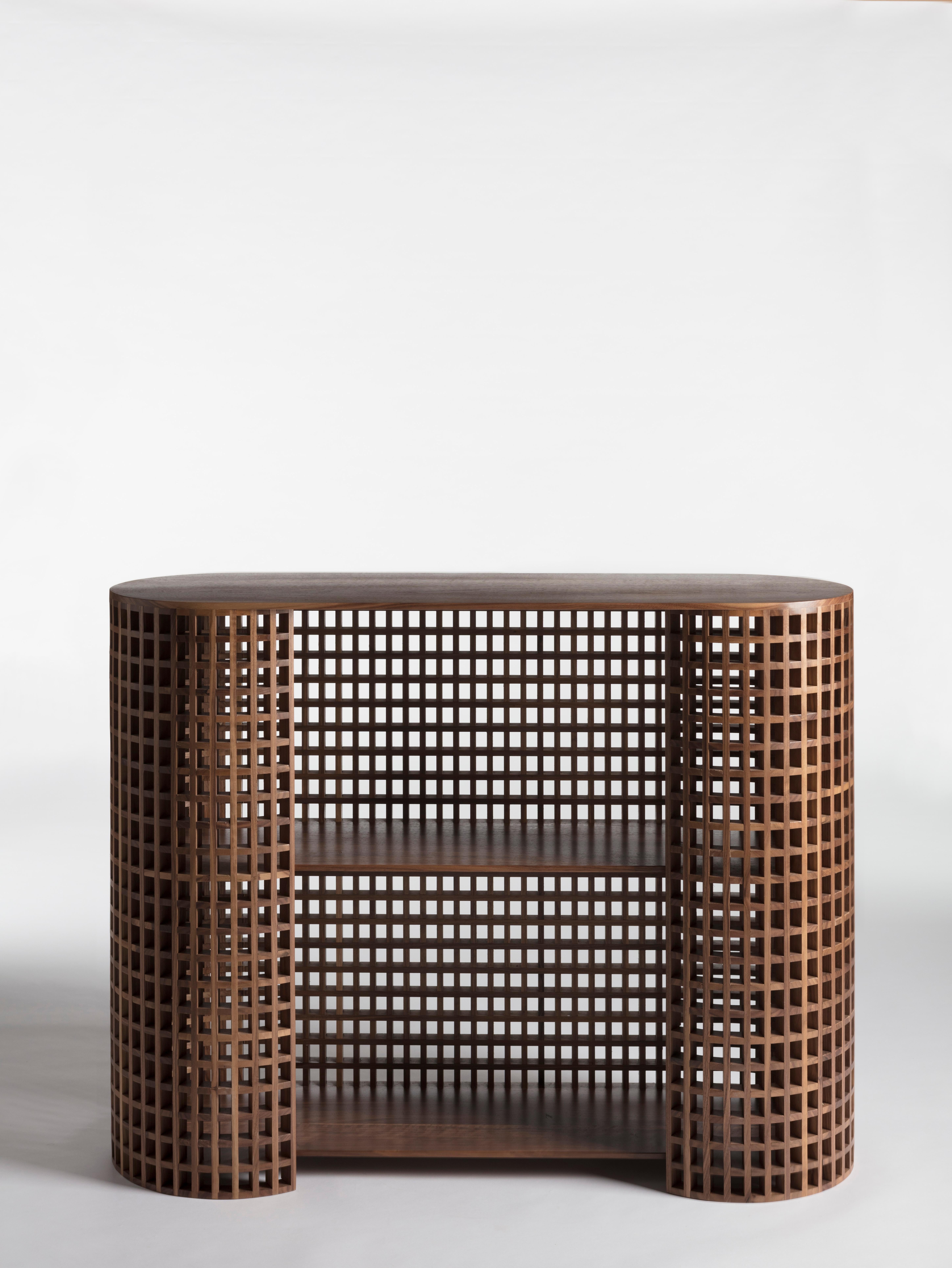 Carabottino is a contemporary and crafted cabinet, a sideboard with shelvs in European walnut, it is a wooden grating that is presented in a two-dimensional form traditionally made of wooden
strips, it is considered to be an accessory element of