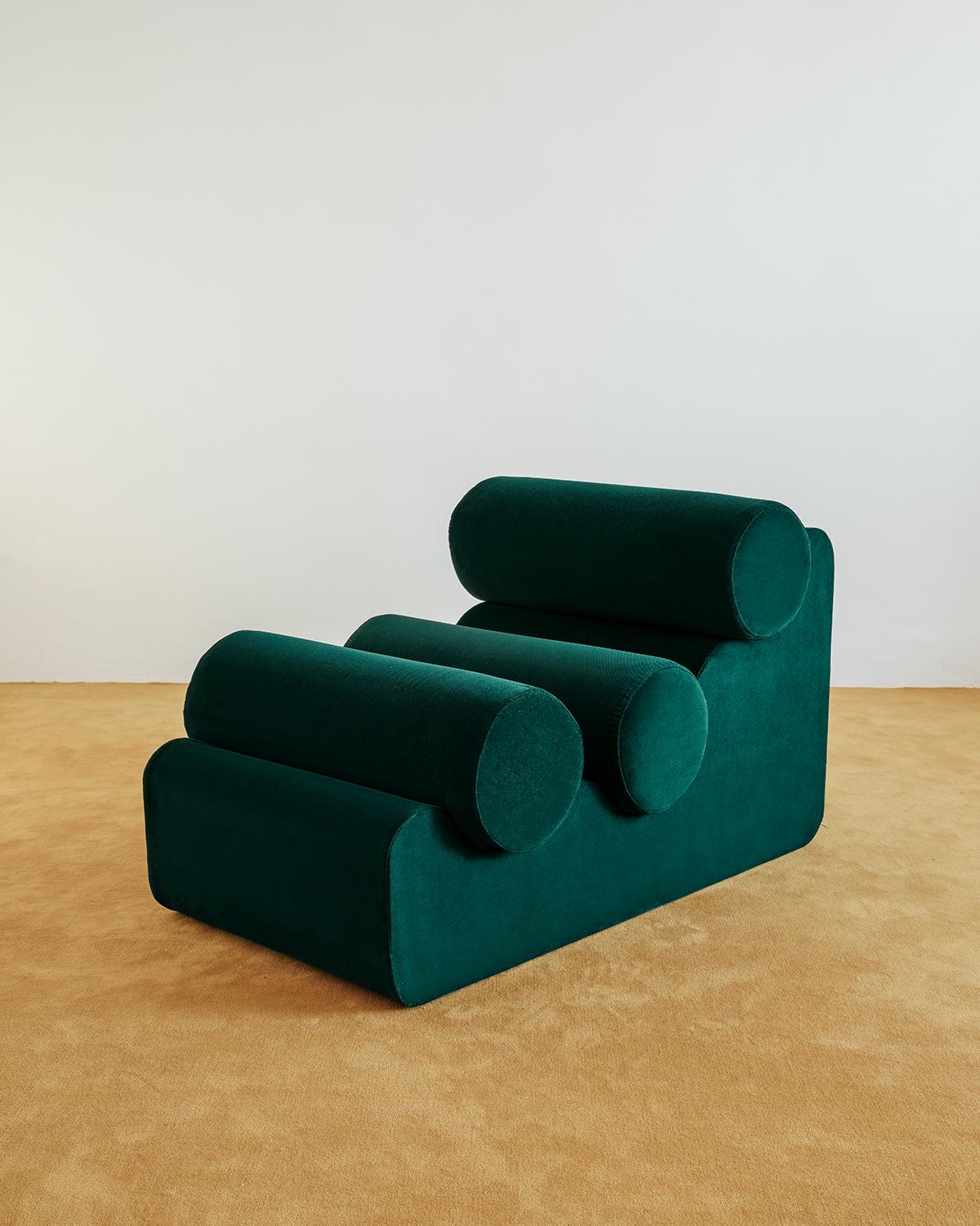 La Pepino is a collection of only seating, which consists of the repetition of cylindrical cushions, supported by an organically shaped base. Every piece comes entirely upholstered in customizable fabric, and plays with the different points of