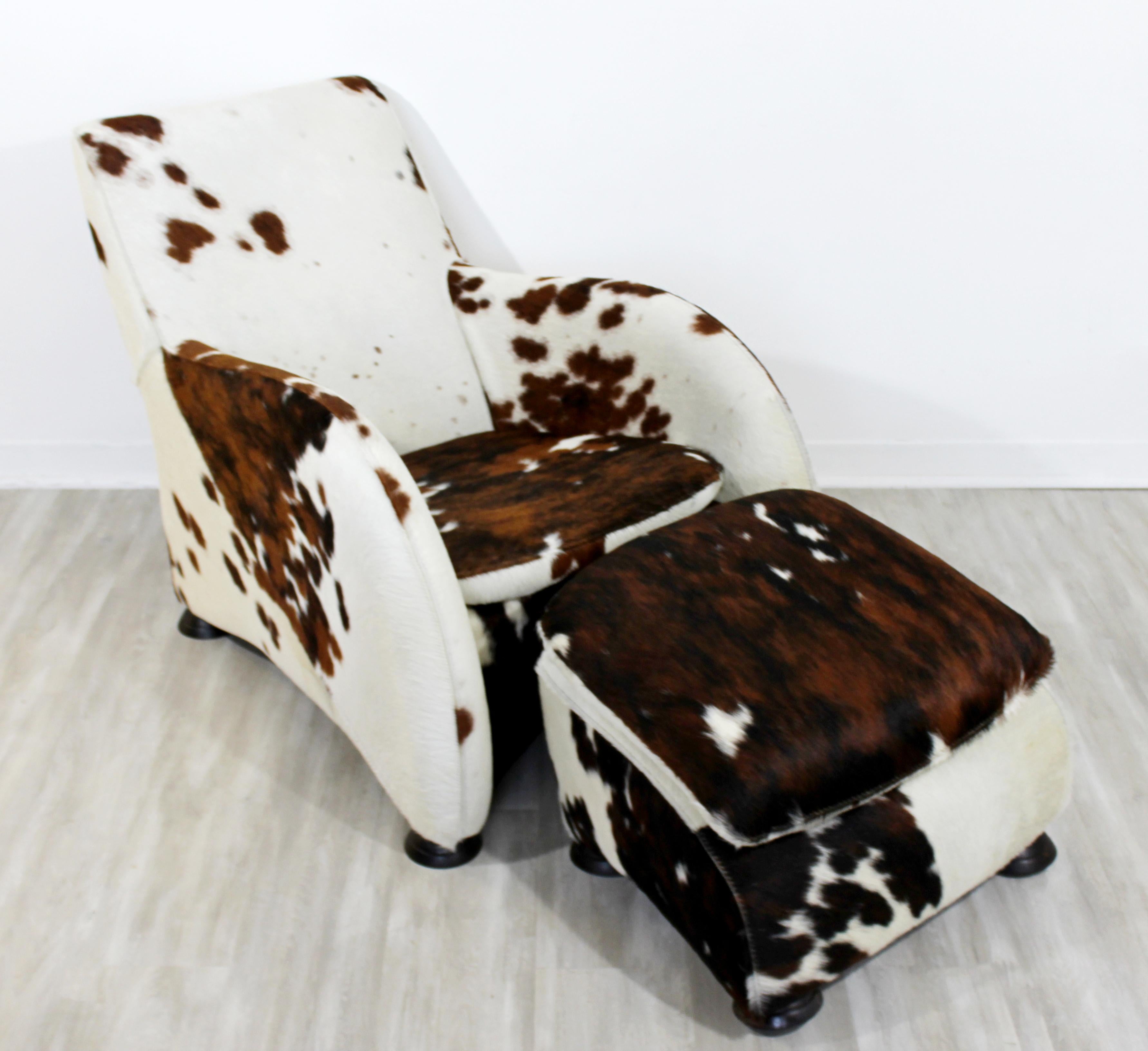 For your consideration is a magnificent, brown and black cow hide lounge armchair and matching ottoman, by Stone International. In excellent condition. The dimensions of the chair are 28.5