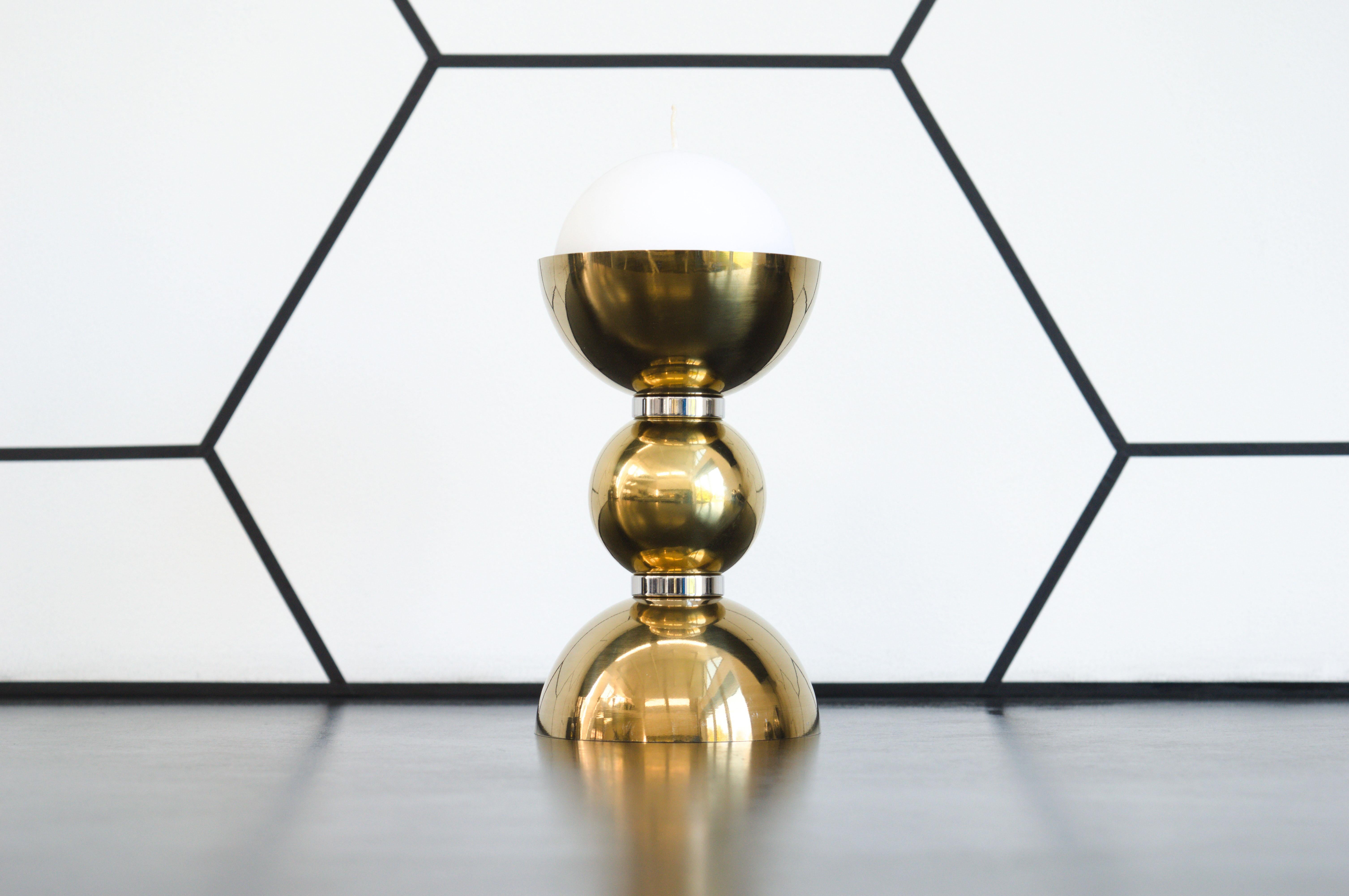 Contemporary candlestick created from polished stainless steel spheres and domes, sharing the form of the Apollo Table. The golden colour of the candlestick mimics the thermal insulation blankets on the Apollo Lunar Module, used during the missions