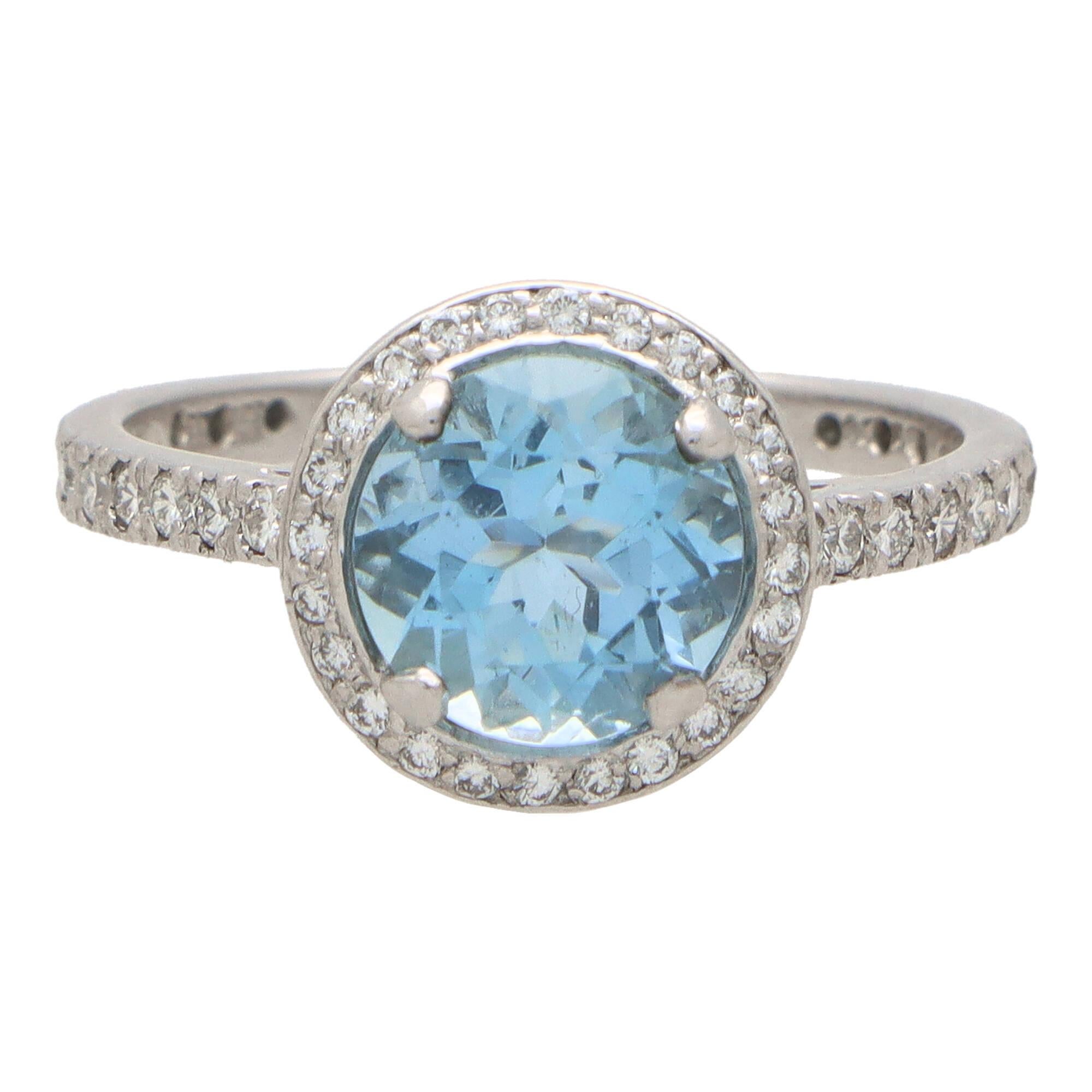Un impresionante anillo de aguamarina y diamantes engastado en platino.

La pieza está engastada en el centro con una hermosa aguamarina talla redonda de 1,72 quilates de color azul cielo, engastada con seguridad con cuatro garras. Esta aguamarina